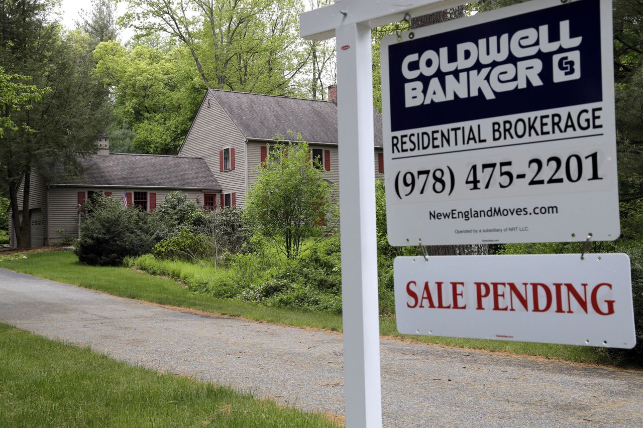 A “sale pending” sign sits in front of a home in North Andover, Massachusetts, on Tuesday.