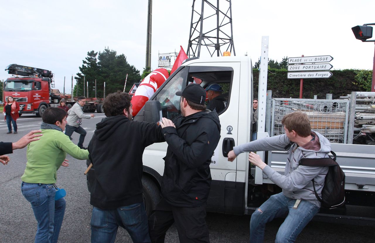 Union activists block the entrance of an industrial area in Boucau, France, on Thursday.