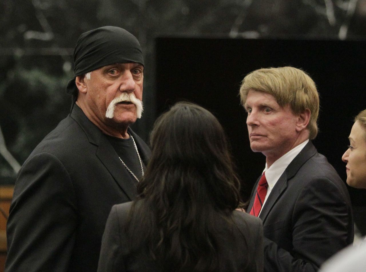 In this March 21 photo, Hulk Hogan, whose given name is Terry Bollea (left), looks on in court moments after a jury returned its decision in St. Petersburg, Florida.