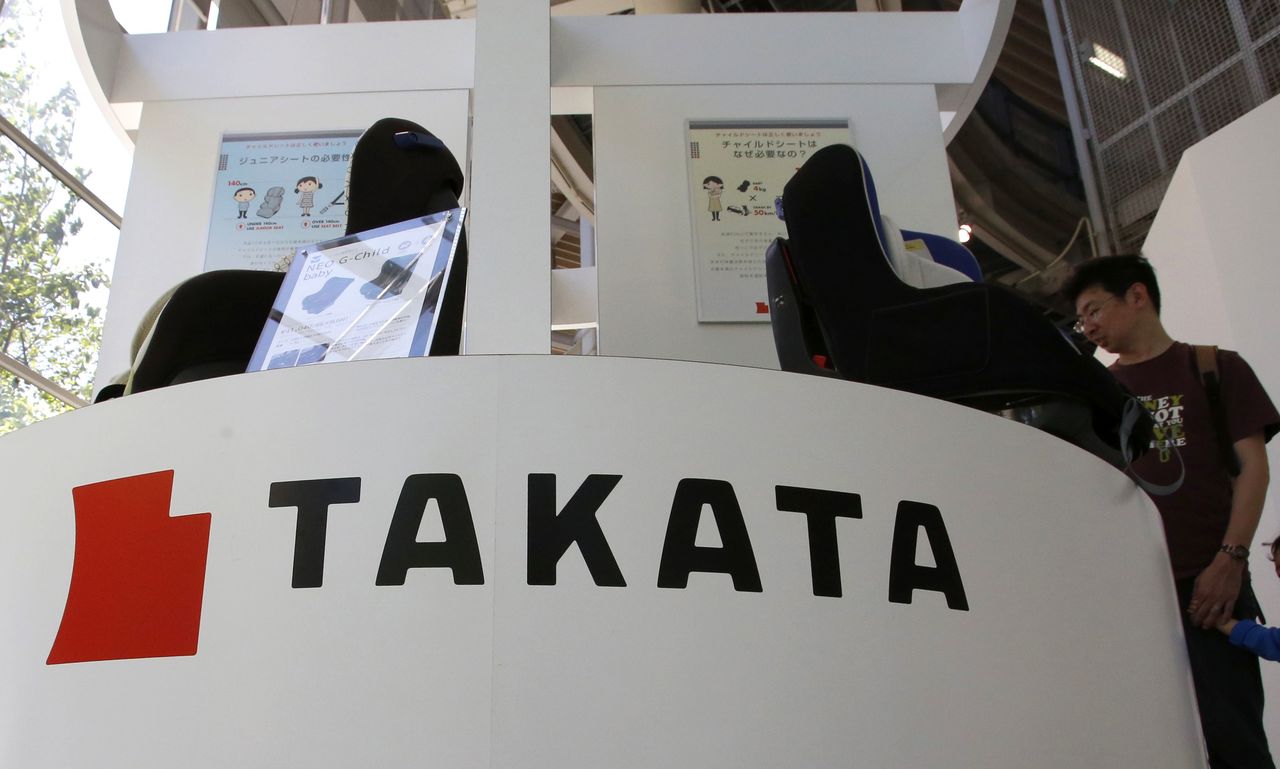 Visitors look at child seats, manufactured and displayed by Takata Corp., at an automaker’s showroom in Tokyo on May 4. The money-losing Japanese air bag maker hired financial advisory and asset management firm Lazard on Thursday to help tackle financial problems and massive recalls.