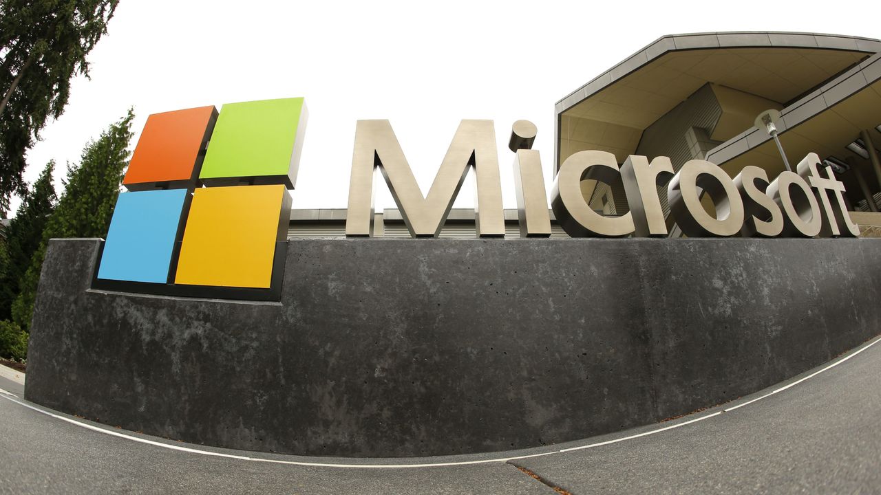 This July 3, 2014, photo, shows the Microsoft Corp. logo outside the Microsoft Visitor Center in Redmond. Microsoft is cutting jobs announced Wednesday, as the company continues its attempts to salvage a rocky entrance into the smartphone market.