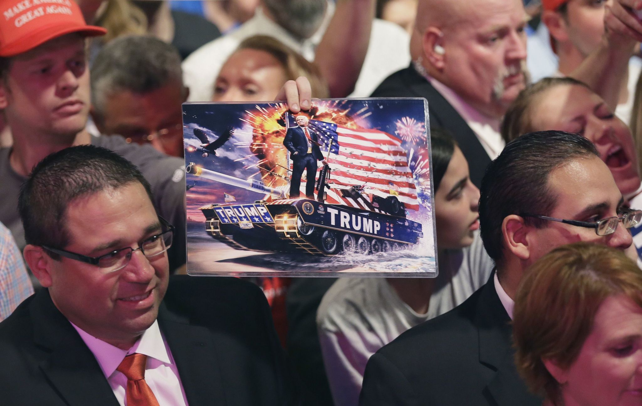 A supporter o Republican presidential candidate Donald Trump holds up a photo of him during a rally at Gilley’s in Dallas on Thursday.sw