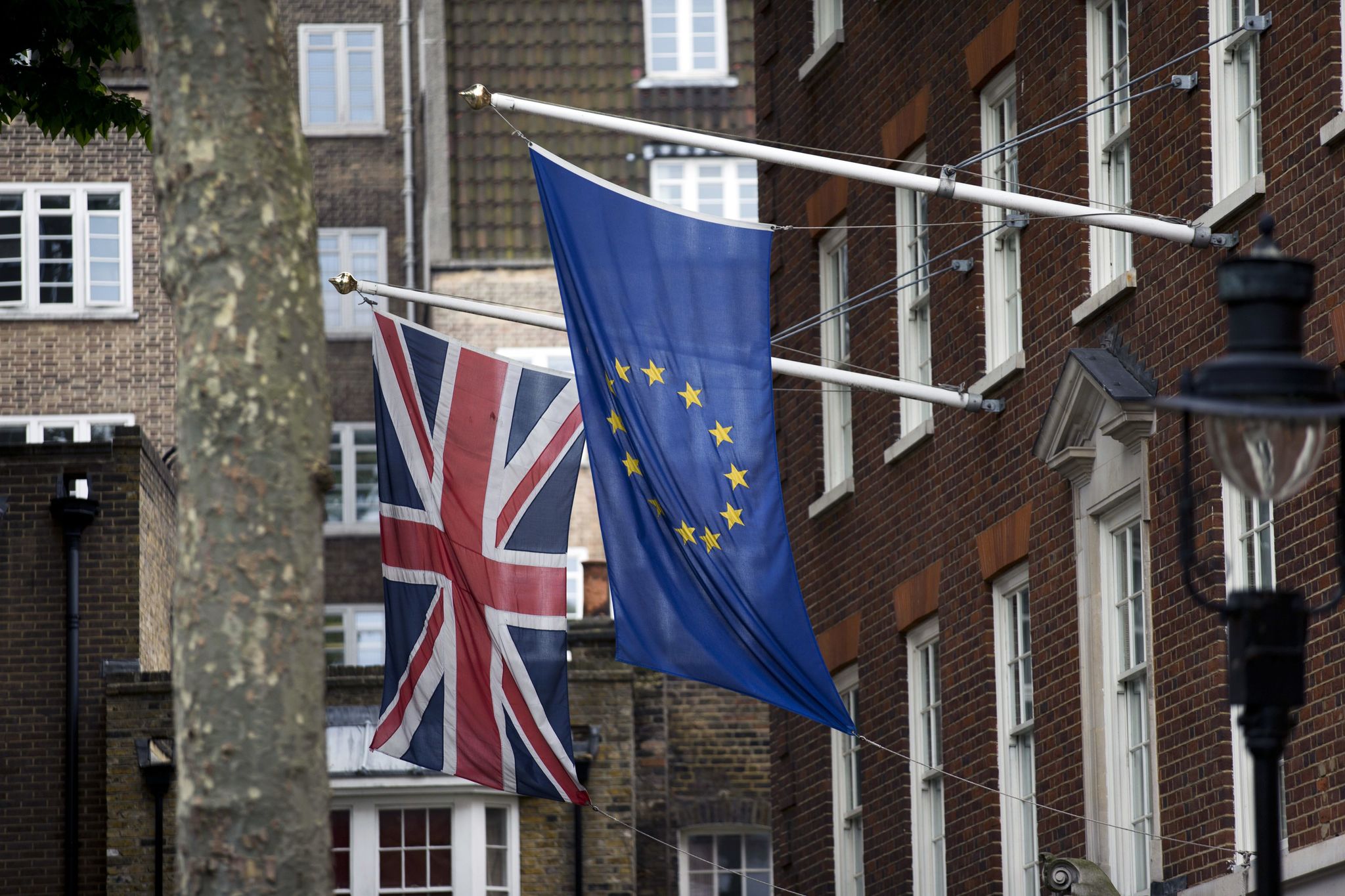 A European and British flag are displayed outside Europe House, the European Parliament’s office in London, on Wednesday. Britain votes on whether to stay in the European Union in a referendum Thursday.