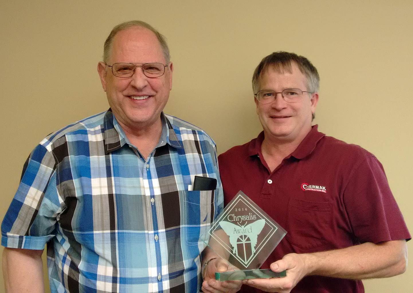 Howard Chermak, president, and Jon Elkins, project developer, of Chermak Construction hold Chrysalis Awards for Remodeling Excellence. The Edmonds firm won one of the awards for the third time in six years.