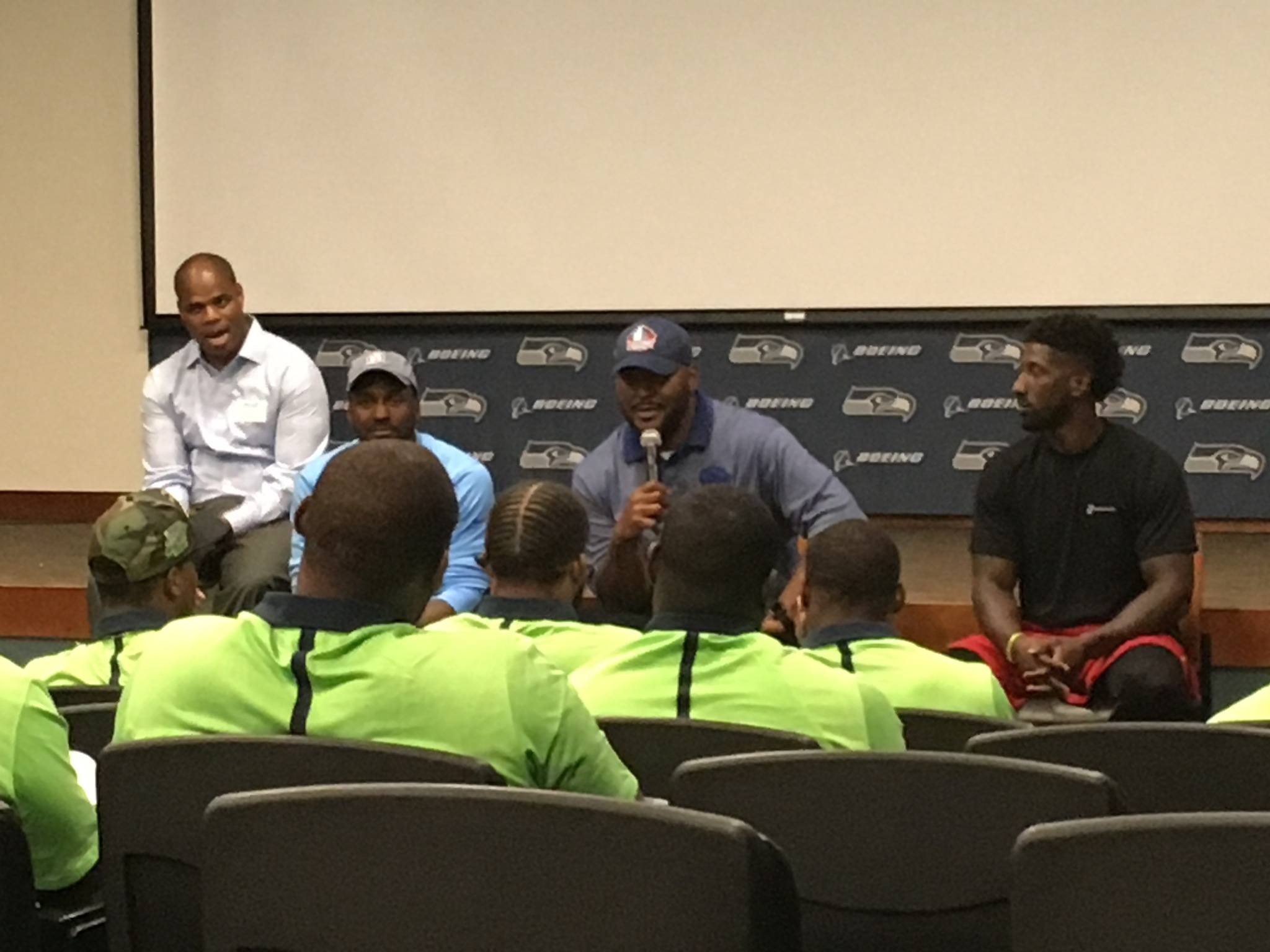 Former Seahawks star Walter Jones (with microphone) addresses Seattle’s rookies during the NFL Rookie Transition Program on Monday at the Virginia Mason Athletic Center in Renton. Jones was one of four former Seahawks, along with Bryce Fisher, Jordan Babineaux and Marcus Trufant, who spoke to the rookies about the off-field issues associated with becoming an NFL player.