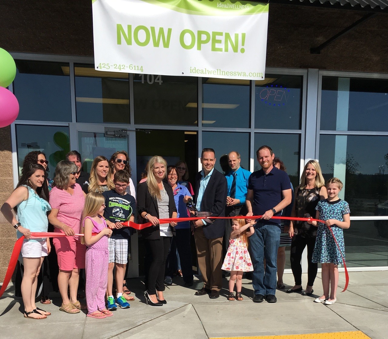Marysville Mayor Jon Nehring helps owner Emily Countryman celebrate the opening of Ideal Wellness in May.