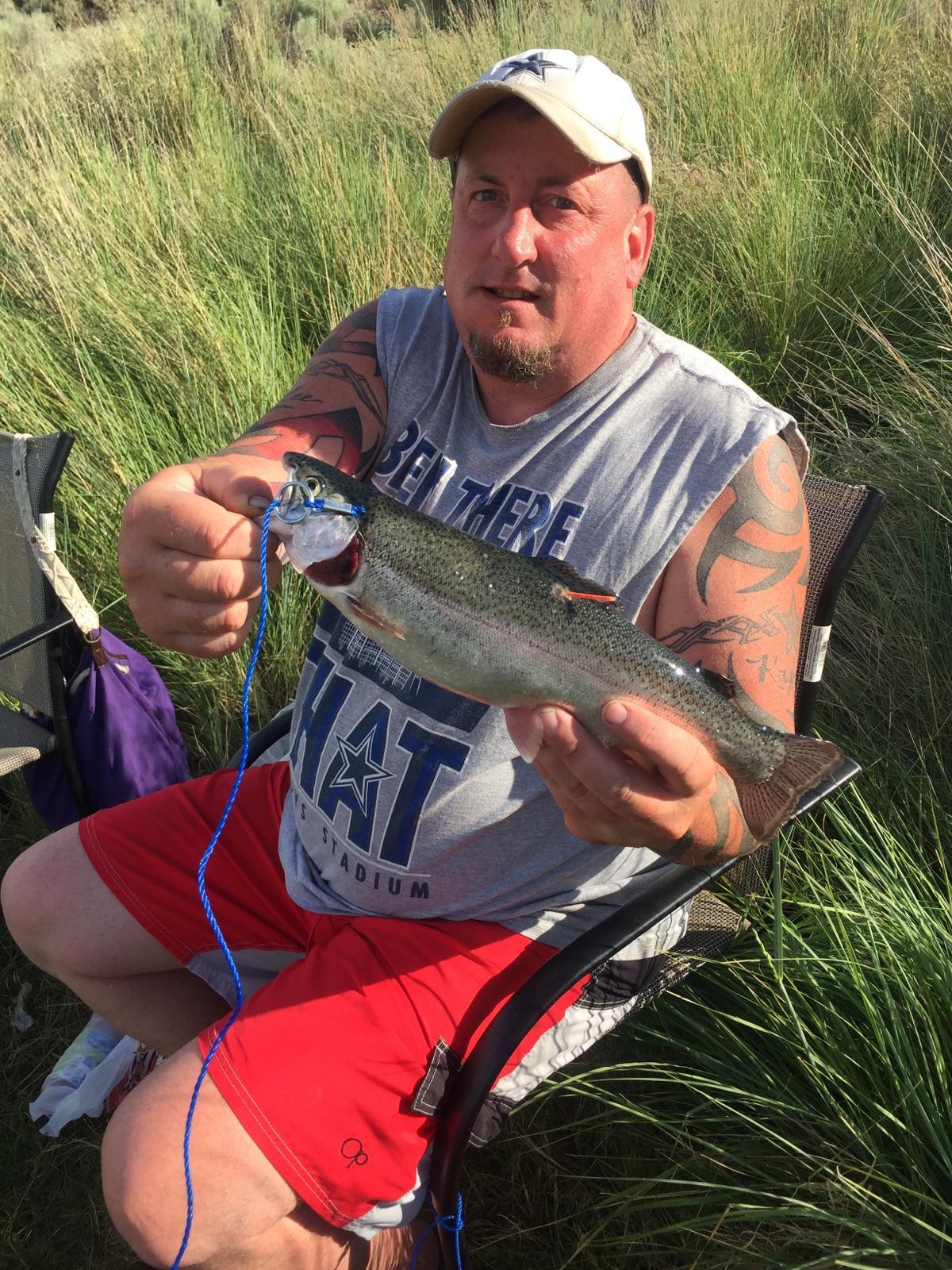Shane Anderson of Belfair displays the tagged trout he caught June 10 on Corral Lake.