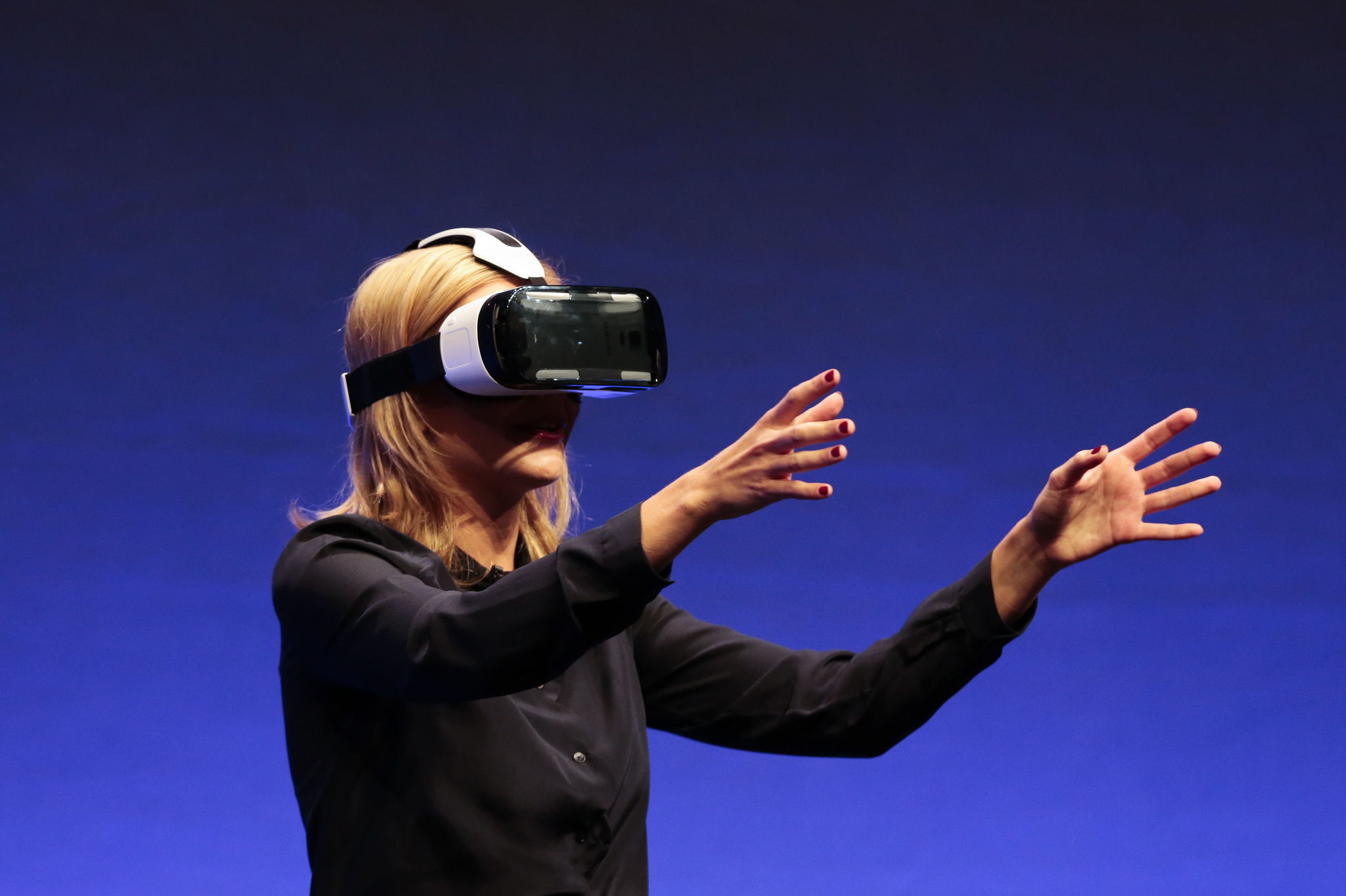 In this Sept. 3, 2014 file photo, British television presenter Rachel Riley shows a virtual-reality headset called Gear VR during an unpacked event of Samsung ahead of the consumer electronic fair IFA in Berlin. Oculus, the virtual reality company acquired by Facebook earlier this year for $2 billion, is holding its first-ever developers conference and is expected to discuss the much-anticipated release of its VR headset for consumers. The two-day Oculus Connect conference begins Friday, Sept. 19, 2014.
