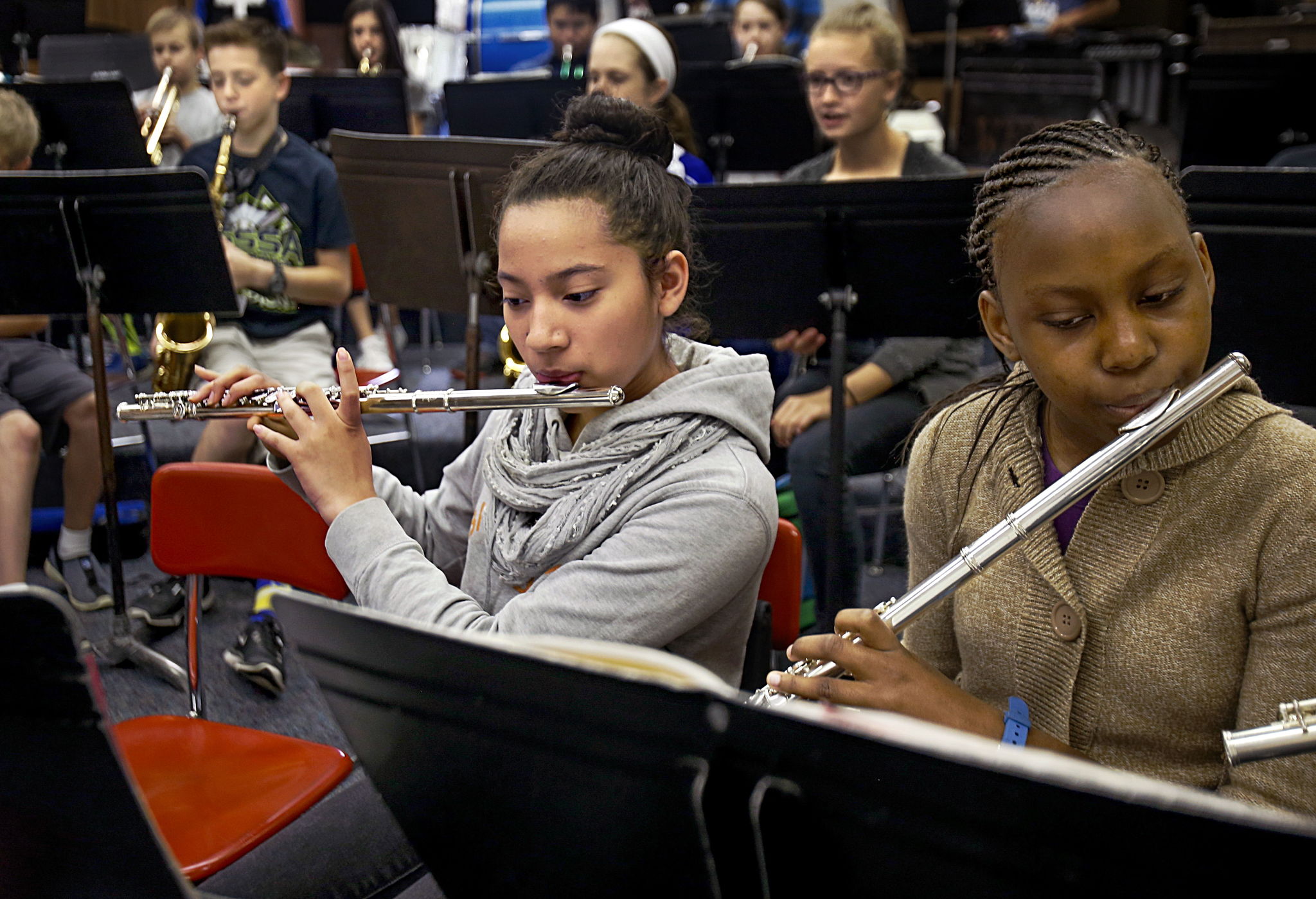 Jazmin Chavez (left) and Melody Atieno play their flutes Wednesday during band practice in Emily Cheever’s class in the North Middle School music room. The flute that Jazmin is playing is one of the 75 band instruments donated by a Seattle couple.