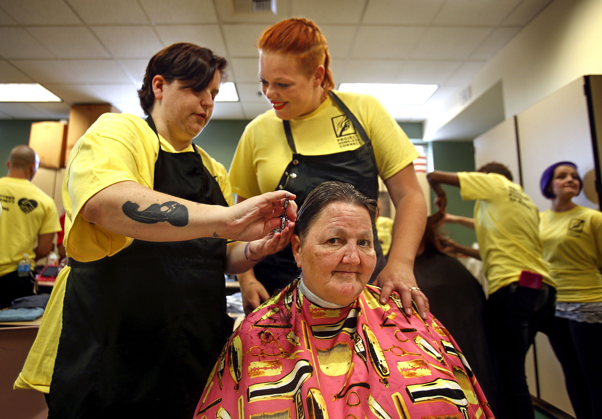 Licensed cosmetologist Kristina Kole (left) and her spouse, cosmetology student Brandy Kole, team up to give Gold Bar’s Cindy Lien a haircut at last year’s Project Homeless Connect. They were volunteers from Paroba College of Cosmetology. Paroba students and staff will be back to help at this year’s event, scheduled for July 14 at Everett High School.