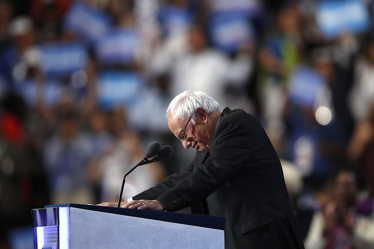 Sen. Bernie Sanders stands at the podium as he is greeted by massive applause during the first day of the Democratic National Convention in Philadelphia on Monday. (AP Photo/Paul Sancya)
