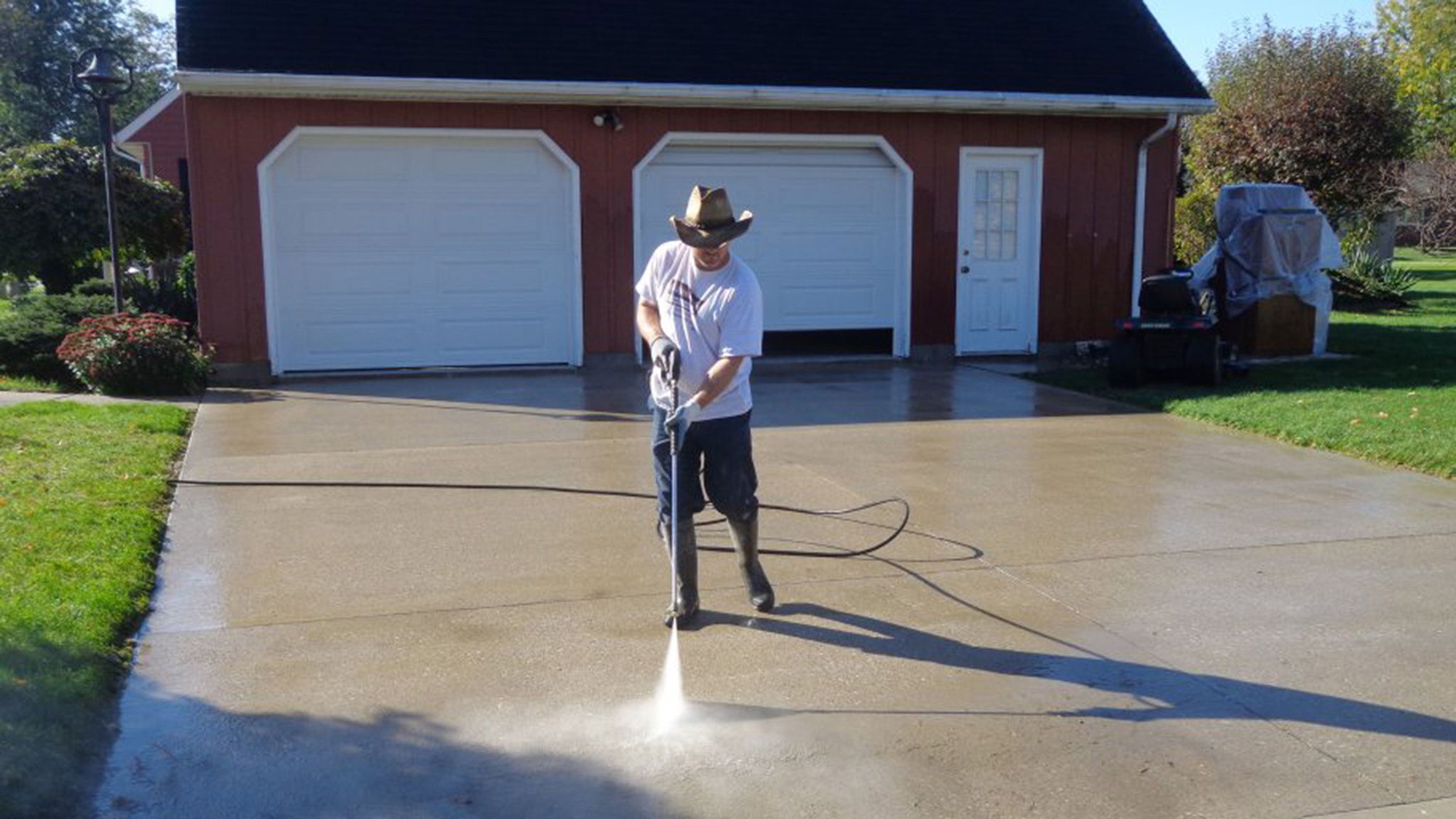 Pressure washing a driveway is an easy way to get it clean. It also works great for garage doors and more.