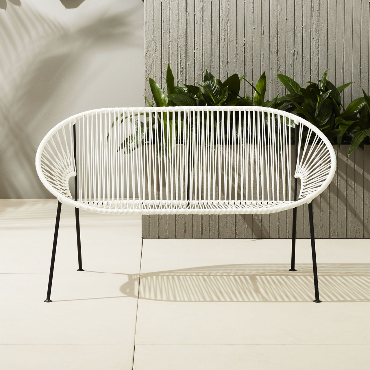 Joanna Carden, of Joanna Carden Interiors in Washington, D.C., suggests buying bigger outdoor pieces in neutrals for longer staying power. She likes the Ixtapa Loveseat, with its bright-white PVC cords fanned out into an oval (cb2.com).