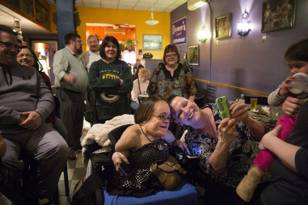 Gaelynn Lea poses for a photo with fan Carla Melander, right, before performing a show at Beaners Central Coffee House on March 4 in Duluth, Minn.
