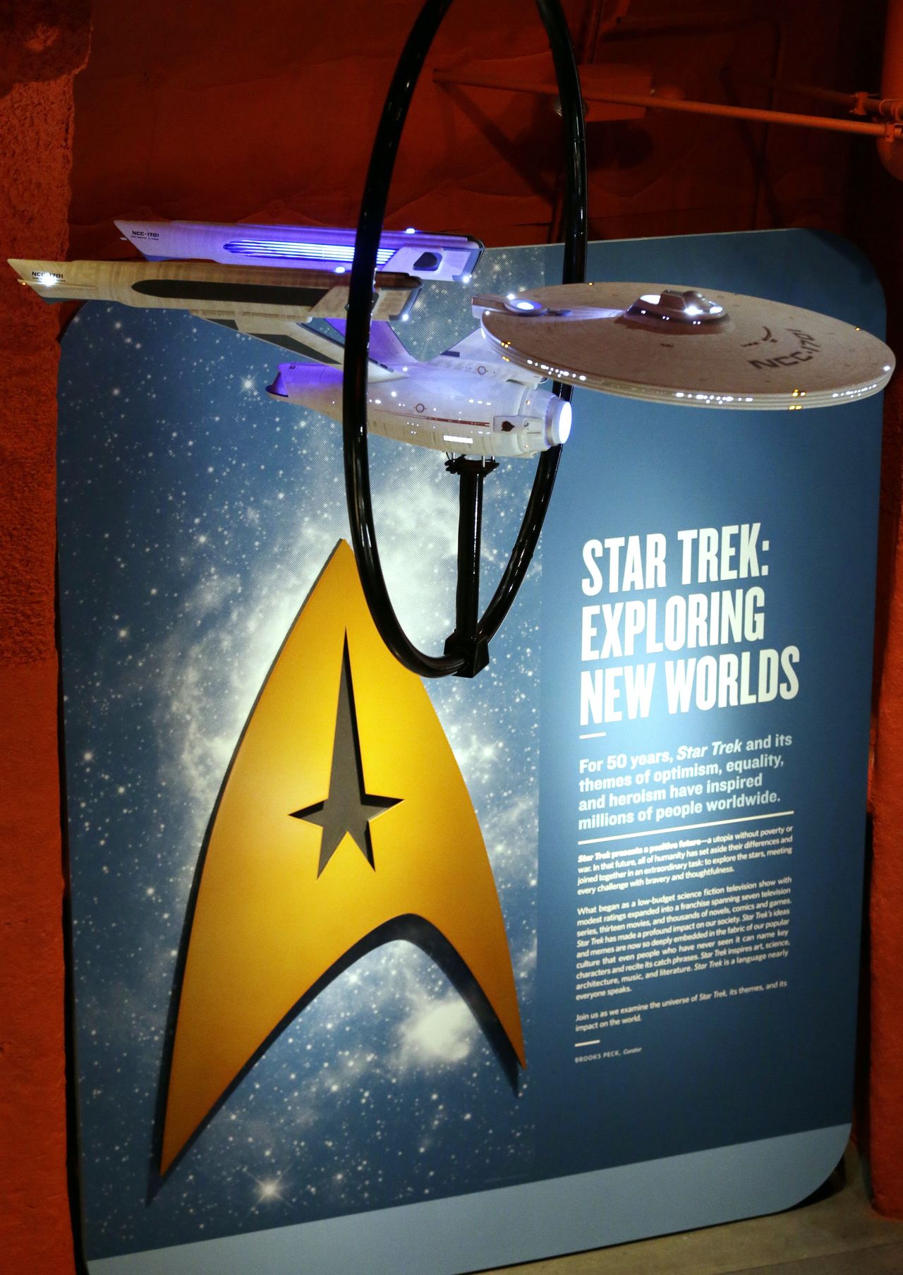 A model of the USS Enterprise, NCC-1701, hangs above information about the exhibit.
