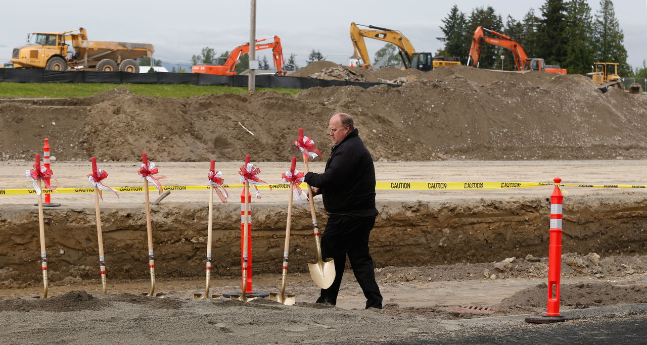 With construction equipment in the background, Lakewood School District Facilities Supervisor Dale Leach picks up shovels after a groundbreaking ceremony Wednesday for the new Lakewood High School. The school is set to be finished in 2017. It’s one of the many new construction projects happening in the Lakewood area.