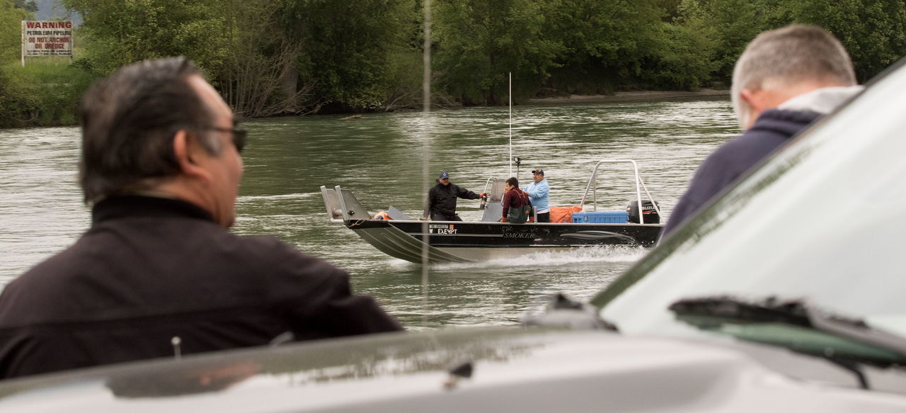 Tribal fish and game officers watch fishermen head upriver while drift net fishing on the Skagit River on Thursday in Mount Vernon.