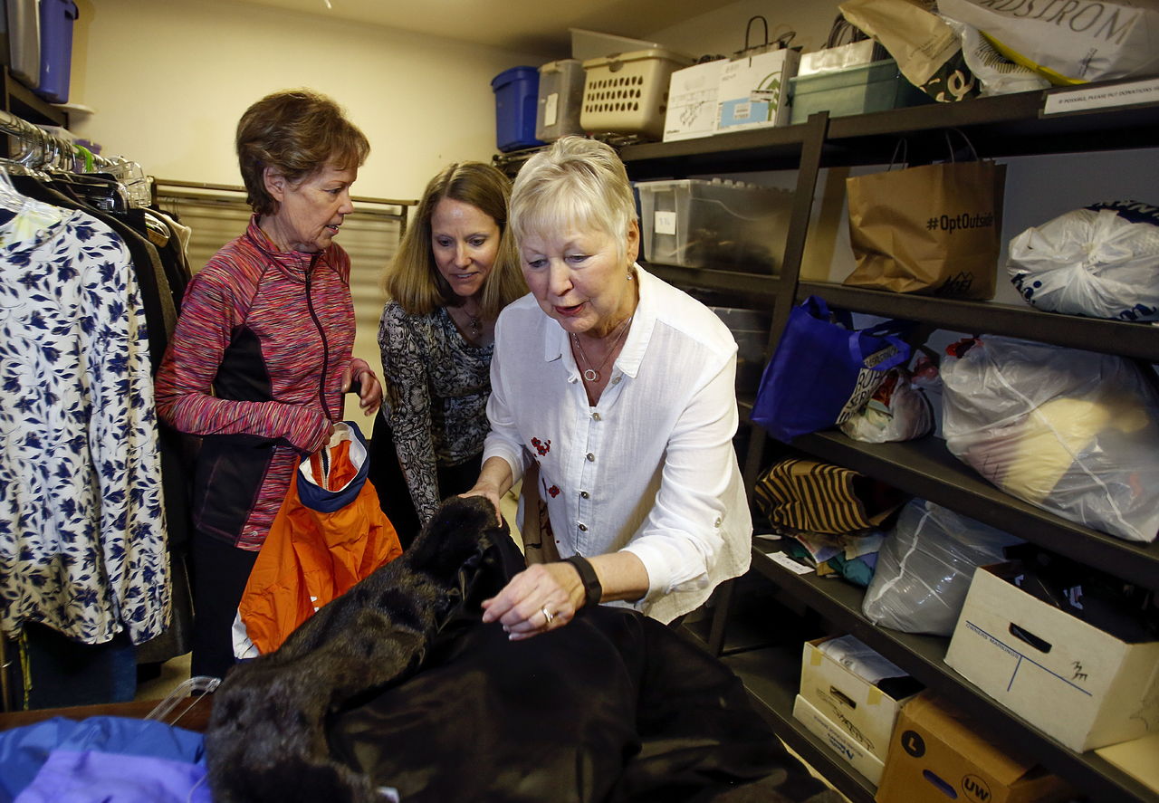 Volunteer Karen Erickson (right) finds something that looks a lot like fur while sorting new arrivals with Vicki Von Stubbe (center), YWCA’s community affairs coordinator, and Kay Reissig at the YWCA office at 3301 Broadway in Everett. Of course, the fur turned out to be faux, but nice faux.