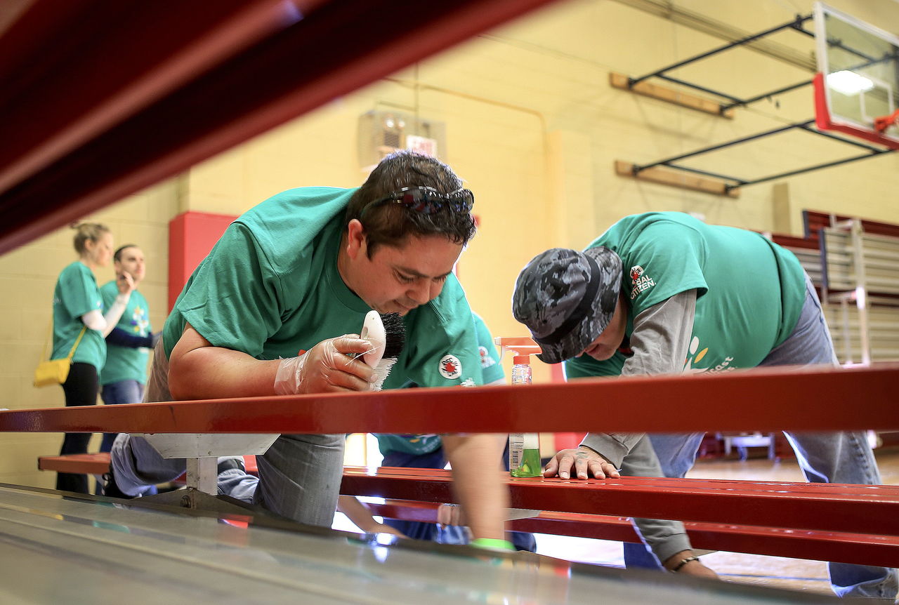 Alex Contreras (left) and Tony Perez clean bleachers Saturday morning at the Marysville Boys & Girls Club.