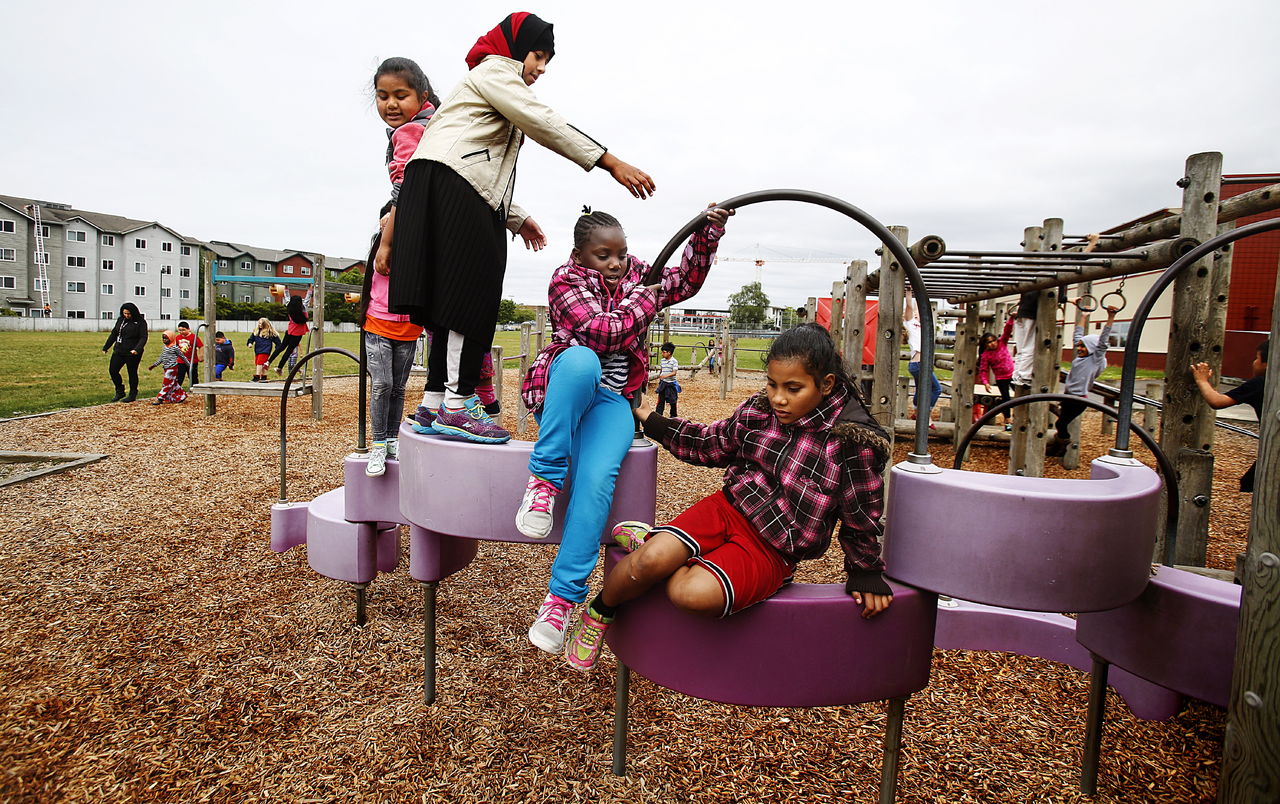 Hawthorne Elementary School kids in Everett climb on a somewhat abstract stairway or bridge structure made of plastic and iron, Monday during recess.