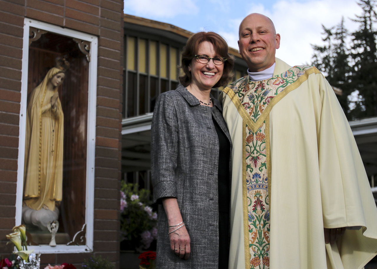 Karin McMicheal with her husband, the Rev. Tom McMichael, at St. Mary’s Catholic Church in Marysville. McMichael converted from the Lutheran Church and has served St. Mary’s for a year.