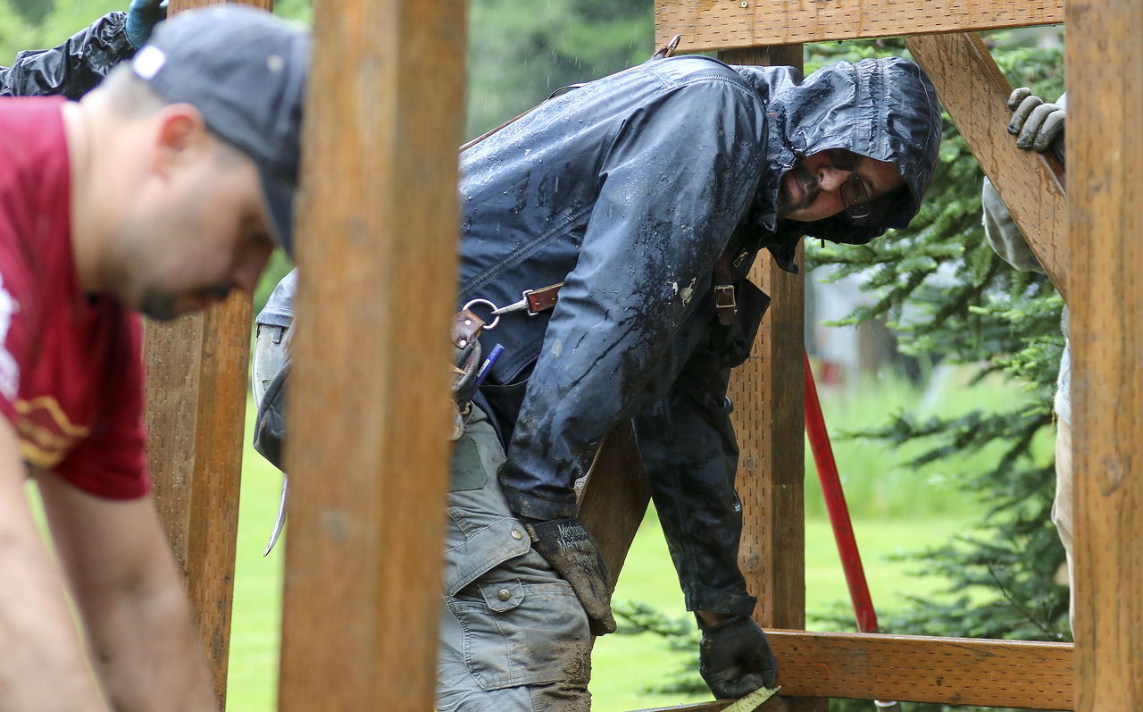 Richardo Banuelos (left) and Brady Prouty check if the landing for a ramp is square Saturday during the Rampathon in Arlington.