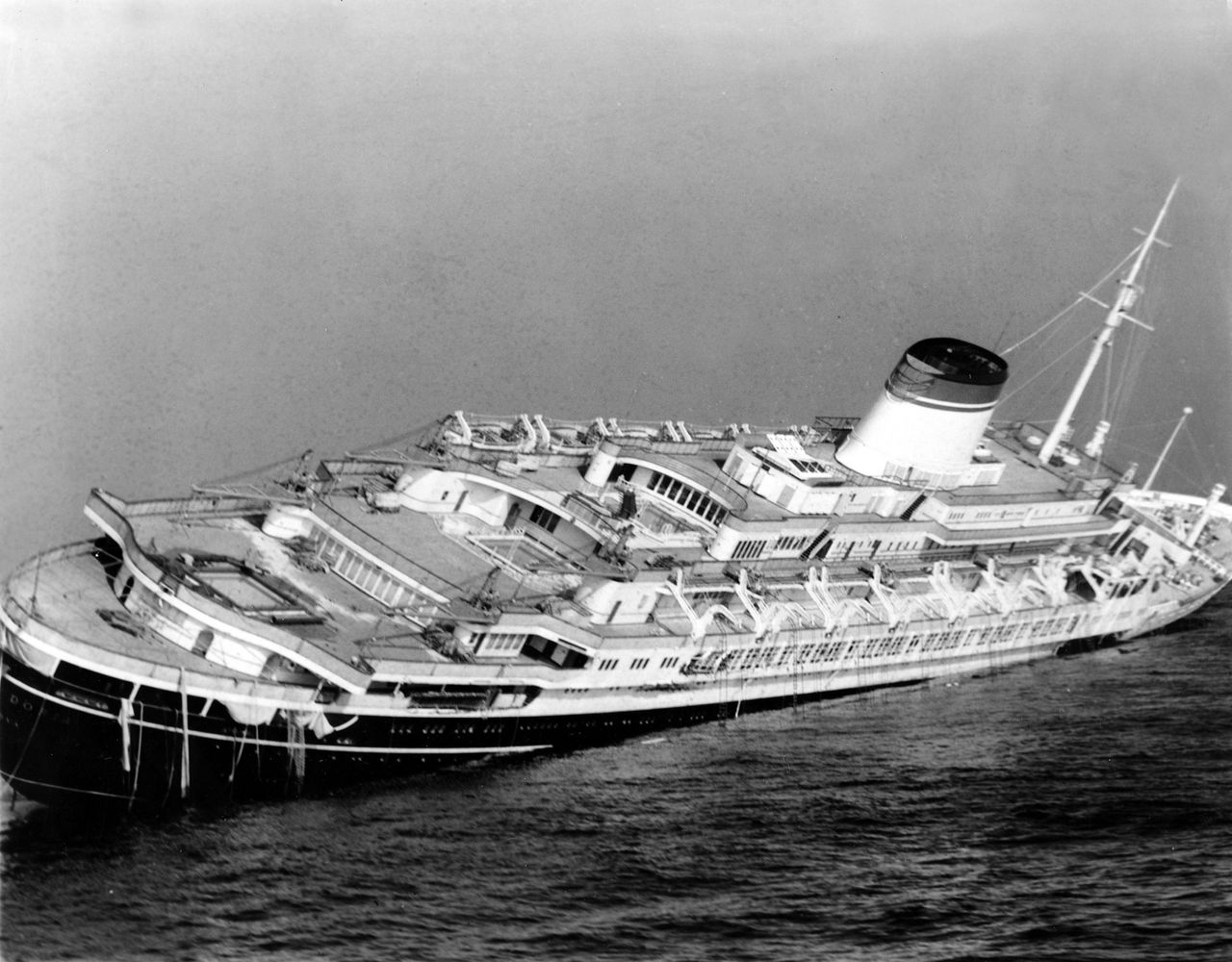 In this July 26, 1956, photo, the Italian luxury liner Andrea Doria lists far over to starboard before sinking 225 feet to the bottom of the Atlantic Ocean 45 miles off Nantucket Island, Massachusetts. Everett-based explorers are preparing to do what 16 others have lost their lives attempting: get a fresh glimpse of the wreckage on the sea floor.