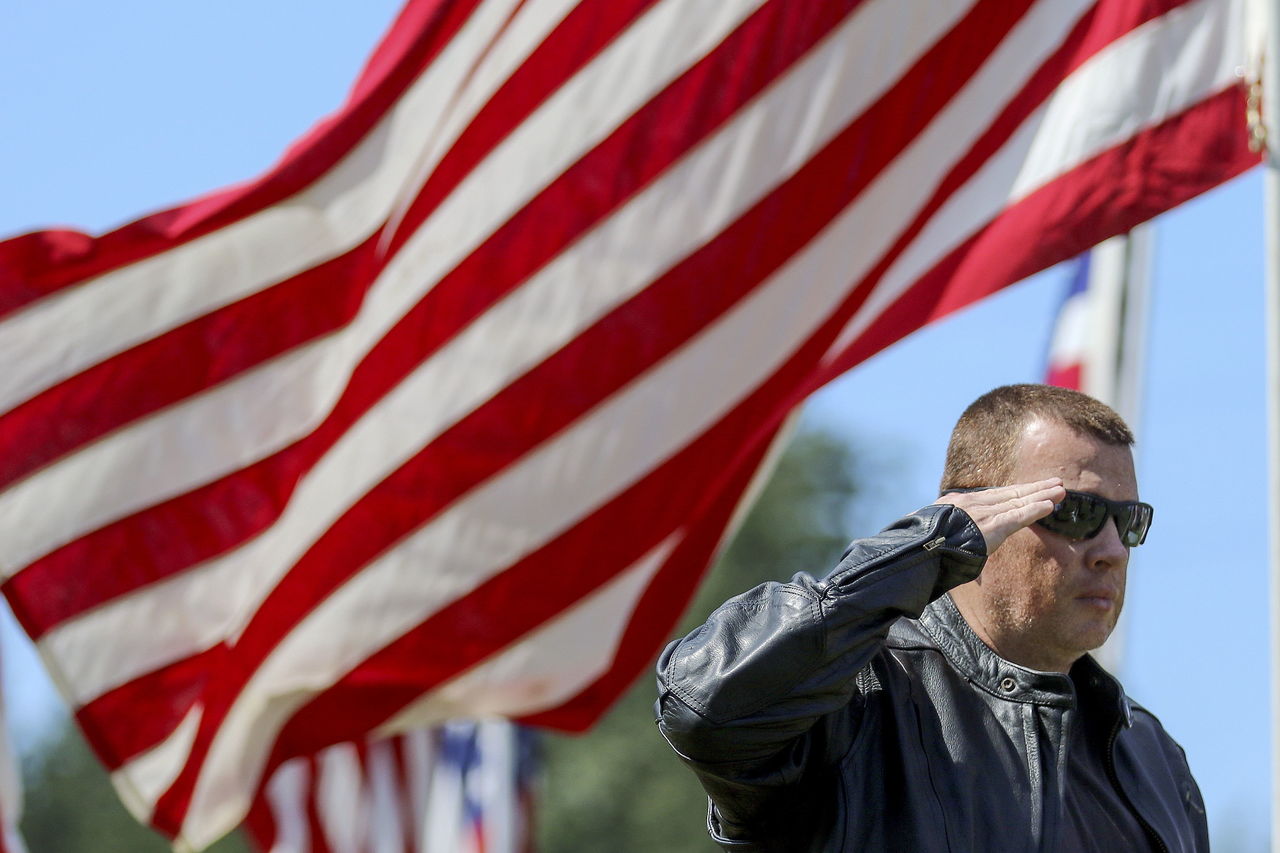 Sgt. First Class William Stiles salutes the presentation of the colors at Marysville Cemetery on Monday.