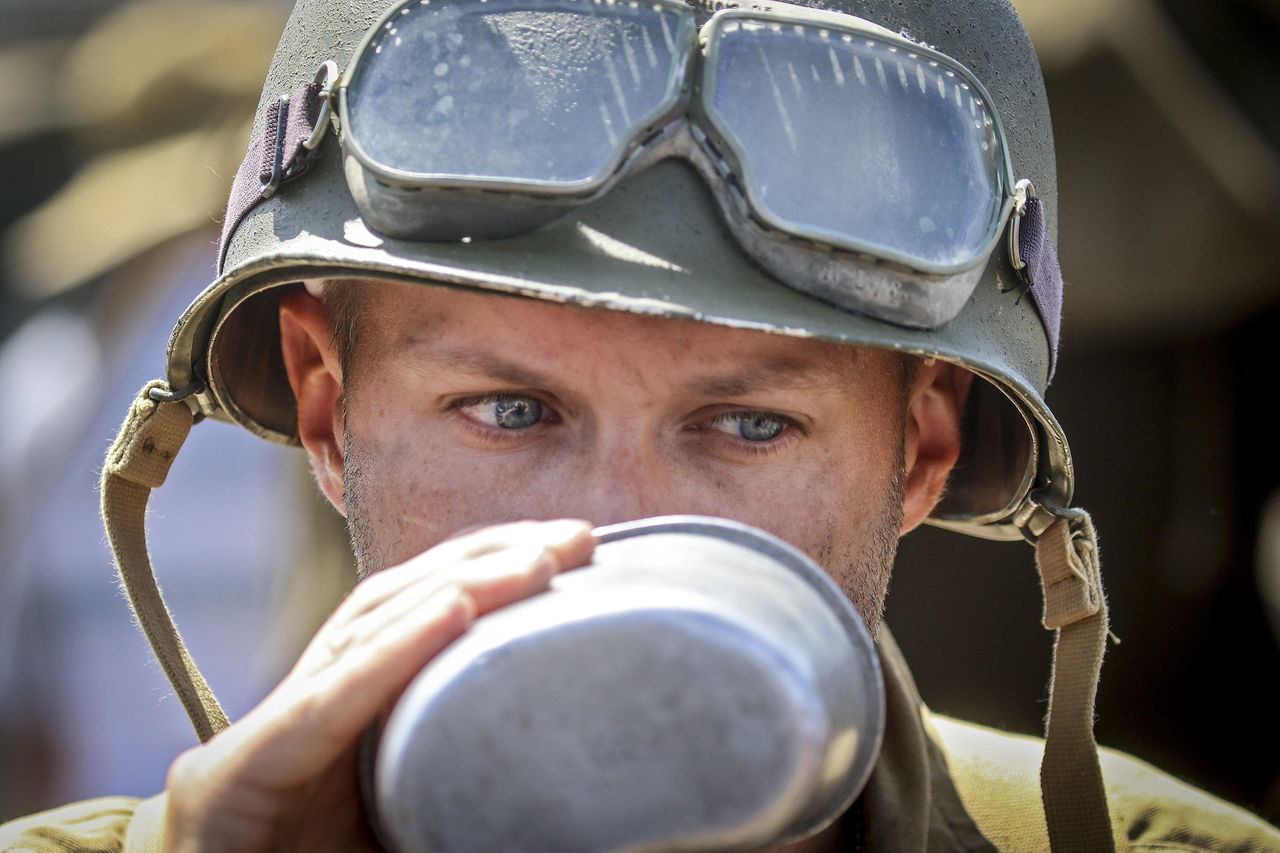 WWII reenactor Blake Nelson takes a drink from his canteen during Tank Fest on Monday.