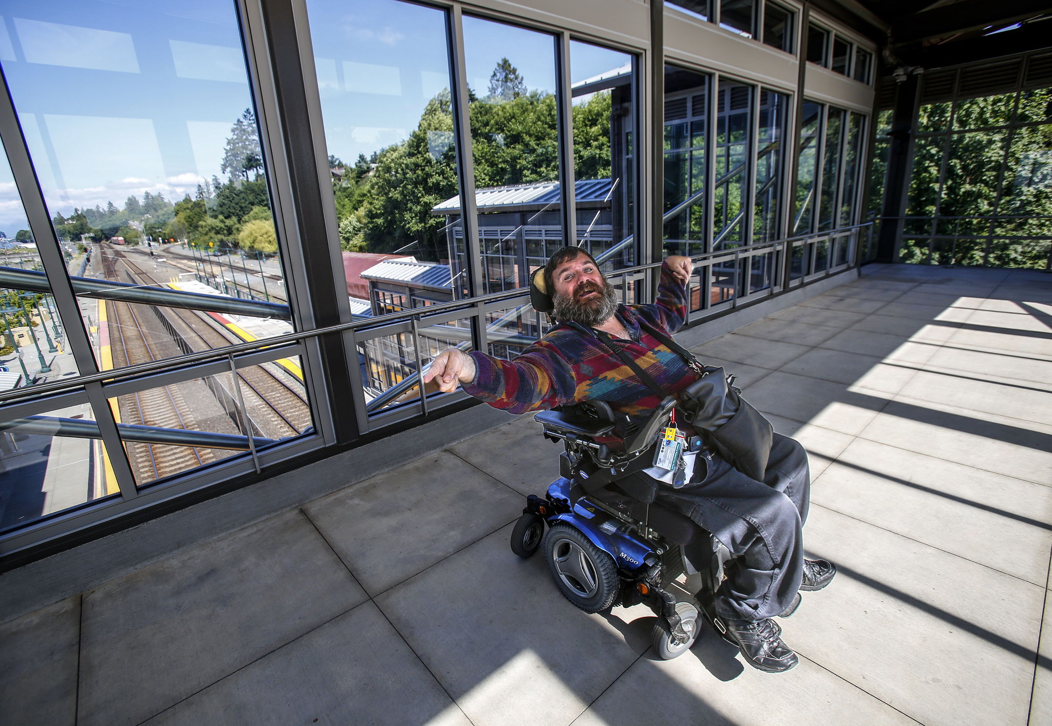 Kent McDaniel, of Everett, explains how difficult it is for him to get from the loading platform on the west side of the tracks to the loading platform on the east side of the tracks. He has to go up an elevator on one side, cross over the pedestrian bridge, then down an elevator on the other side, and navigate the passenger walkways with other passengers both arriving and departing. He is grateful that Sounder recently added staff to help passengers with information about arriving trains.