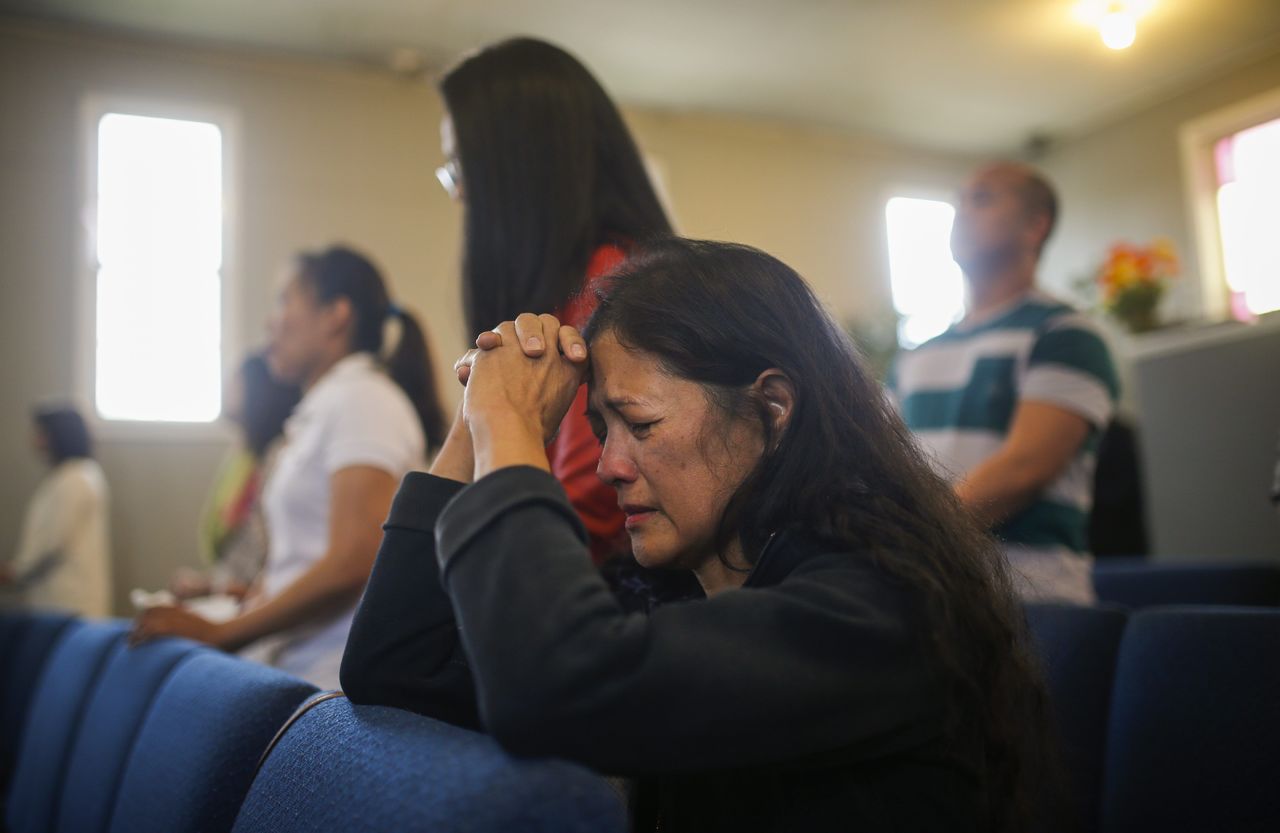 Fort McMurray wildfire evacuee Gloria Trottier prays during a service at the Word of Faith Family Church in Lac la Biche, Canada, on Sunday.