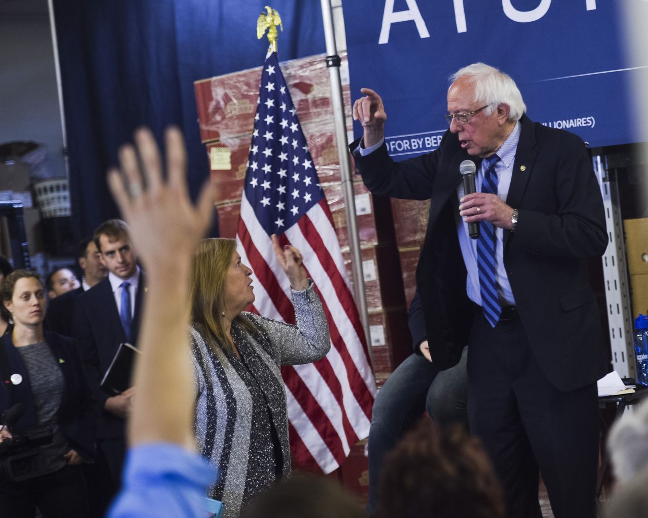 Jane Sanders, wife of Democratic presidential candidate Bernie Sanders, interrupts her husband to let him know he has gone over time and is late for his next speaking engagement in South Charleston, West Virgina, during a campaign event in Kimball, West Virginia, on Thursday.