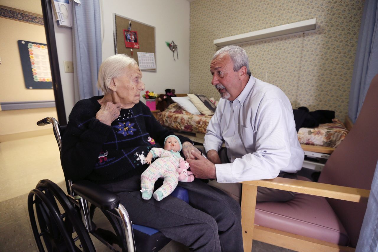 Glen Hotchkiss talks to his mother, Phyllis Hotchkiss, at her nursing home in Adrian, Michigan on April 14. Phyllis, 93, has dementia and is confined to a wheelchair and was involuntarily discharged from her nursing home this year to one further away from her family.