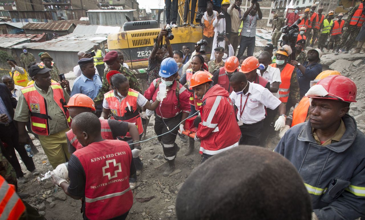 A woman is carried away in a stretcher by medics as she is rescued after being trapped for six days in the rubble of a collapsed building, in the Huruma area of Nairobi, Kenya, on Thursday.