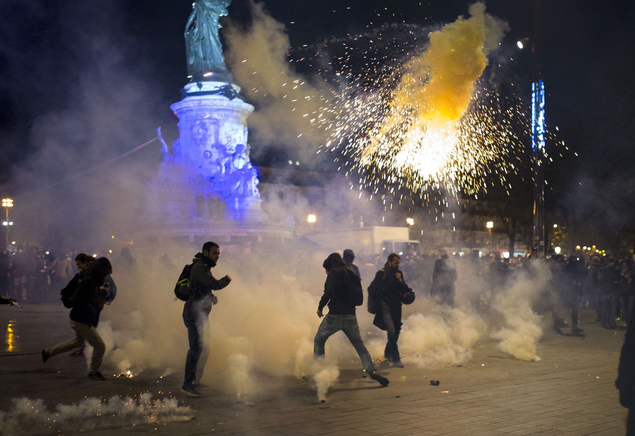 Riot police fire tear gas canisters during clashes with demonstrators gathered at the Place de la Republique in Paris on Sunday.