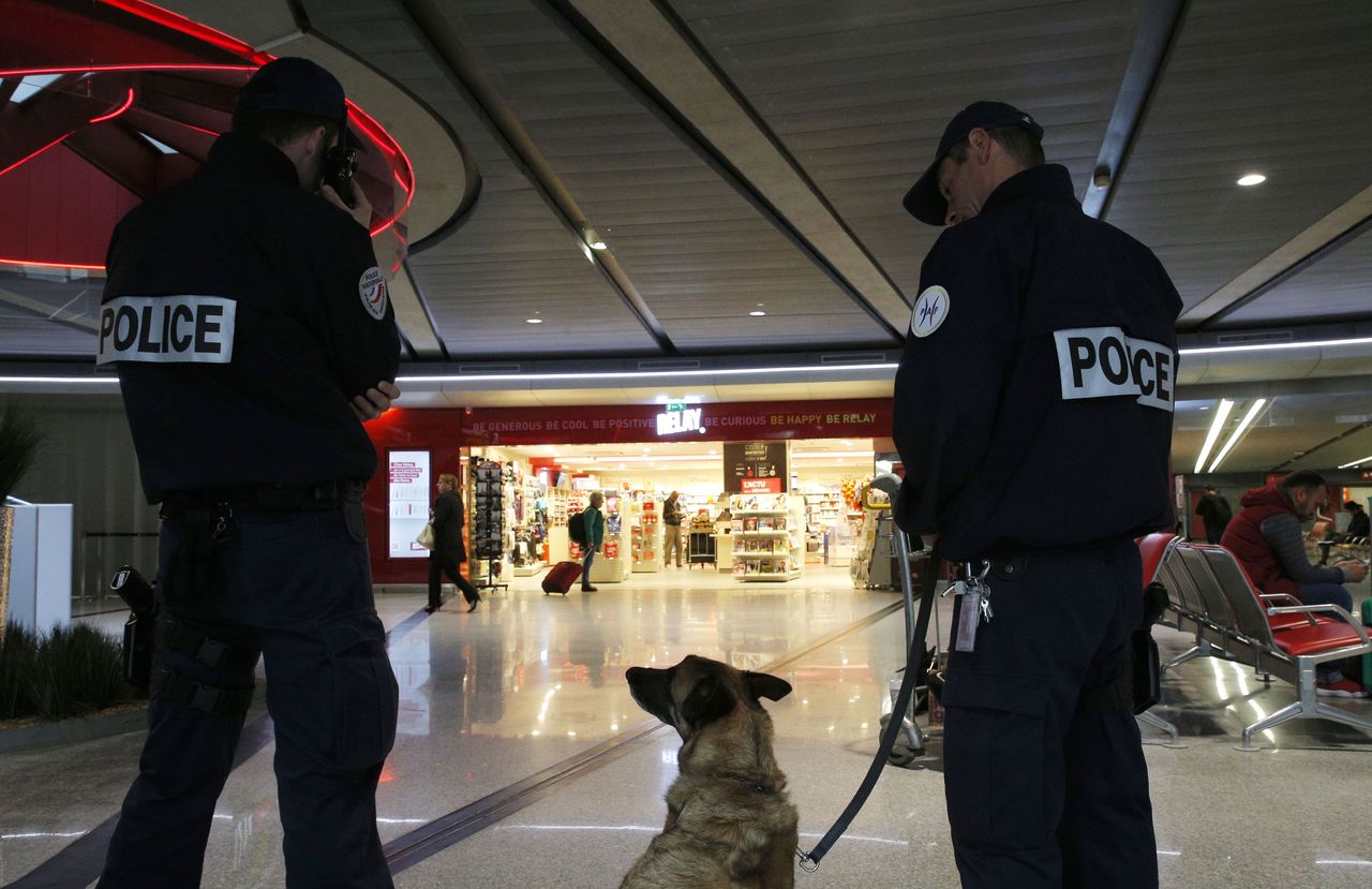 Police officers patrol at Charles de Gaulle airport, outside of Paris, on Thursday.