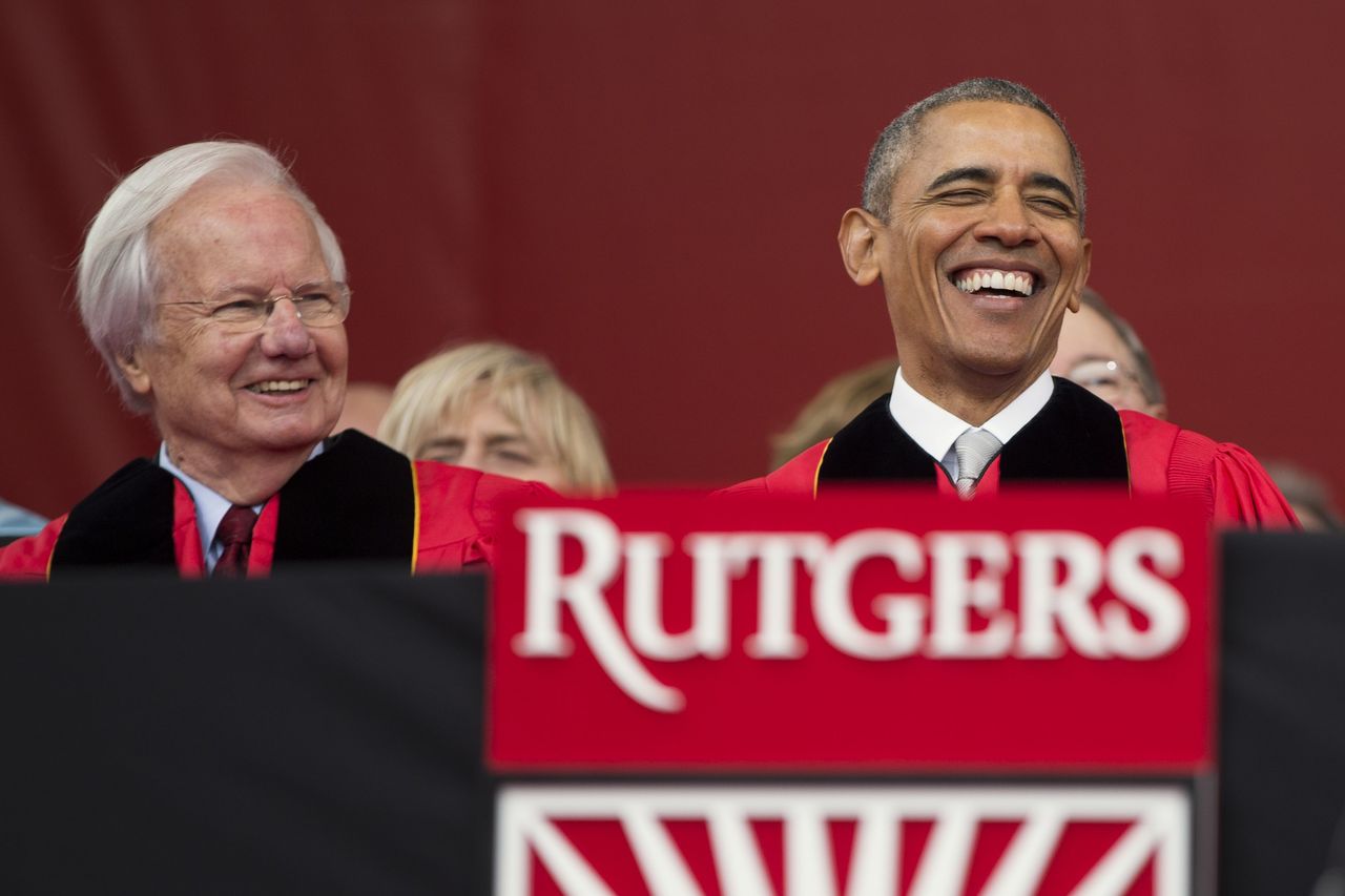 President Barack Obama, right, laughs as he sits with Bill Moyers during Rutgers University’s 250th Anniversary commencement ceremony, Sunday, in New Brunswick, N.J.