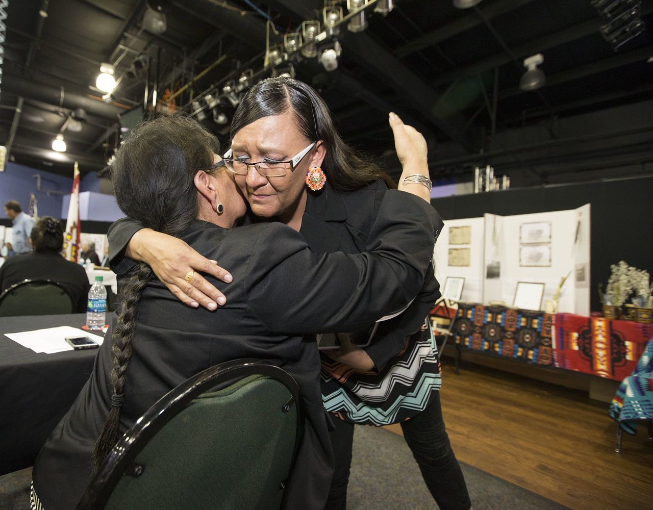 Yufna Soldier Wolf, left, of the Northern Arapaho is hugged by Marcida Eagle Bear on Tuesday, after her presentation to the Army representatives on the Rosebud Reservation.