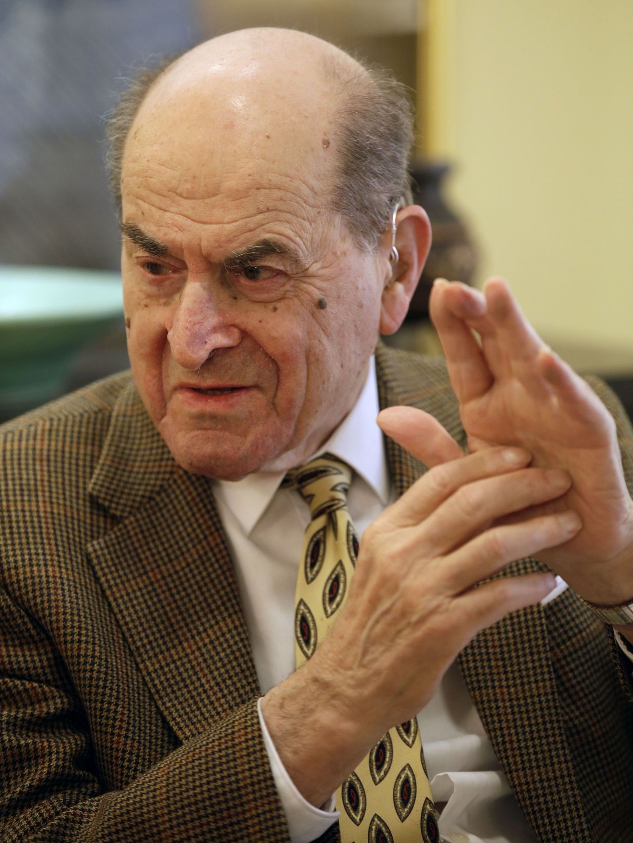In this Feb. 5, 2014, photo, Dr. Henry Heimlich describes the maneuver he developed to help clear obstructions from the windpipes of choking victims, while being interviewed at his home in Cincinnati.