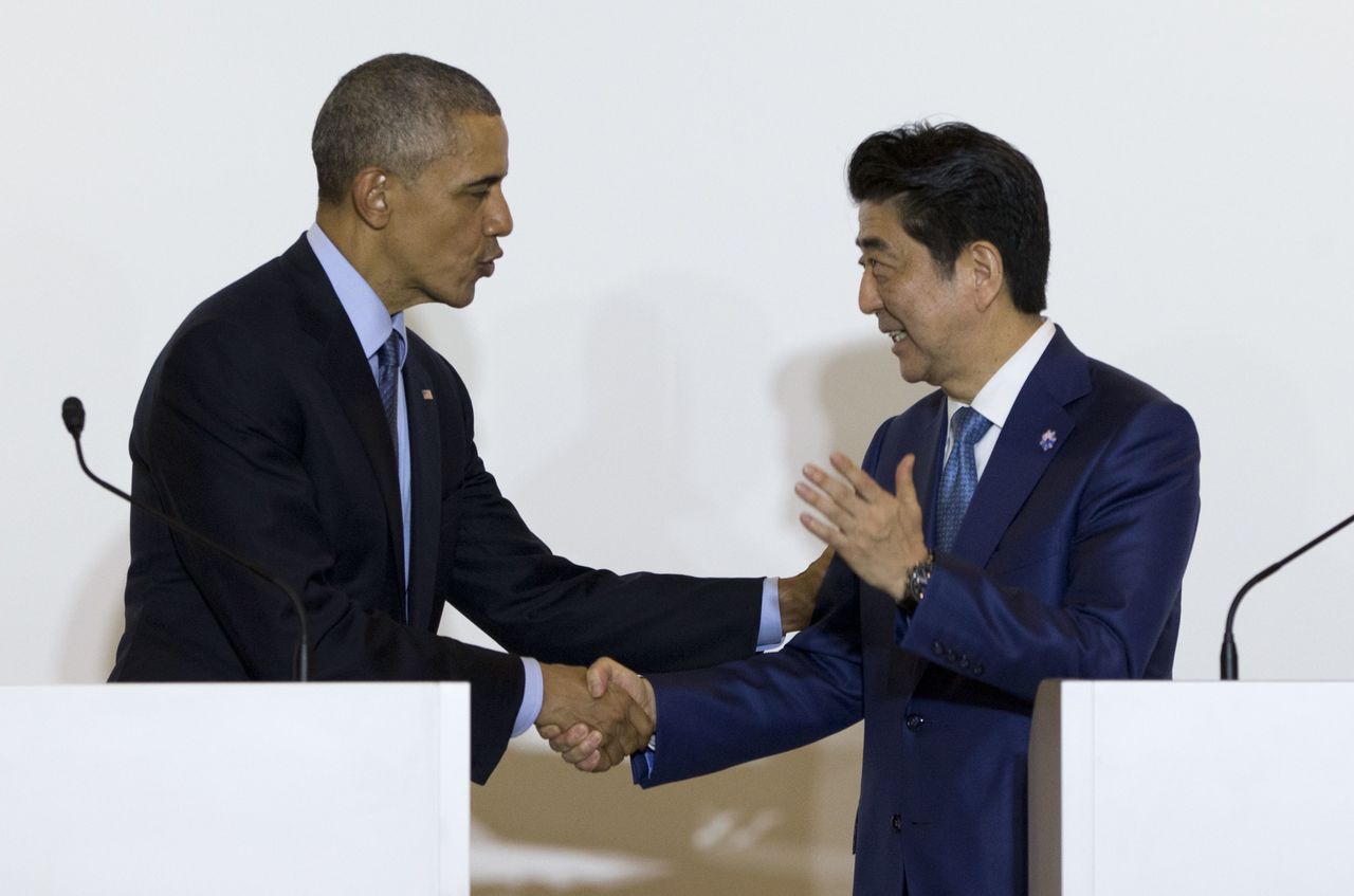 President Barack Obama and Japanese Prime Minister Shinzo Abe shake hands after speaking to media in Shima, Japan, on Wednesday.