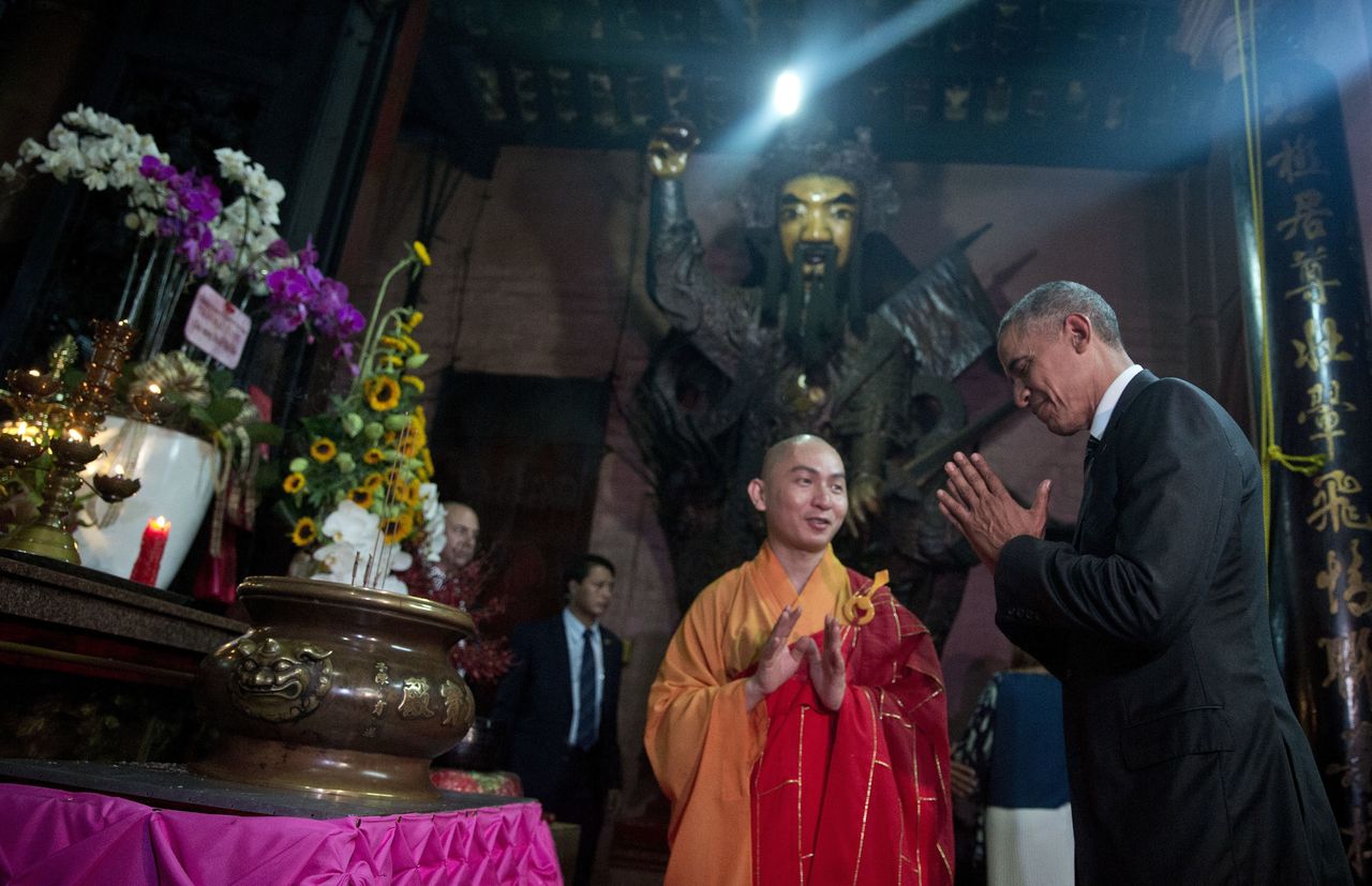 President Barack Obama bows as he visits the Jade Emperor Pagoda with Thich Minh Thong, abbot of the Jade Emperor Pagoda, in Ho Chi Minh City, Vietnam, on Tuesday. The Jade Emperor Pagoda is one of the most notable and most visited cultural destinations in Ho Chi Minh City.