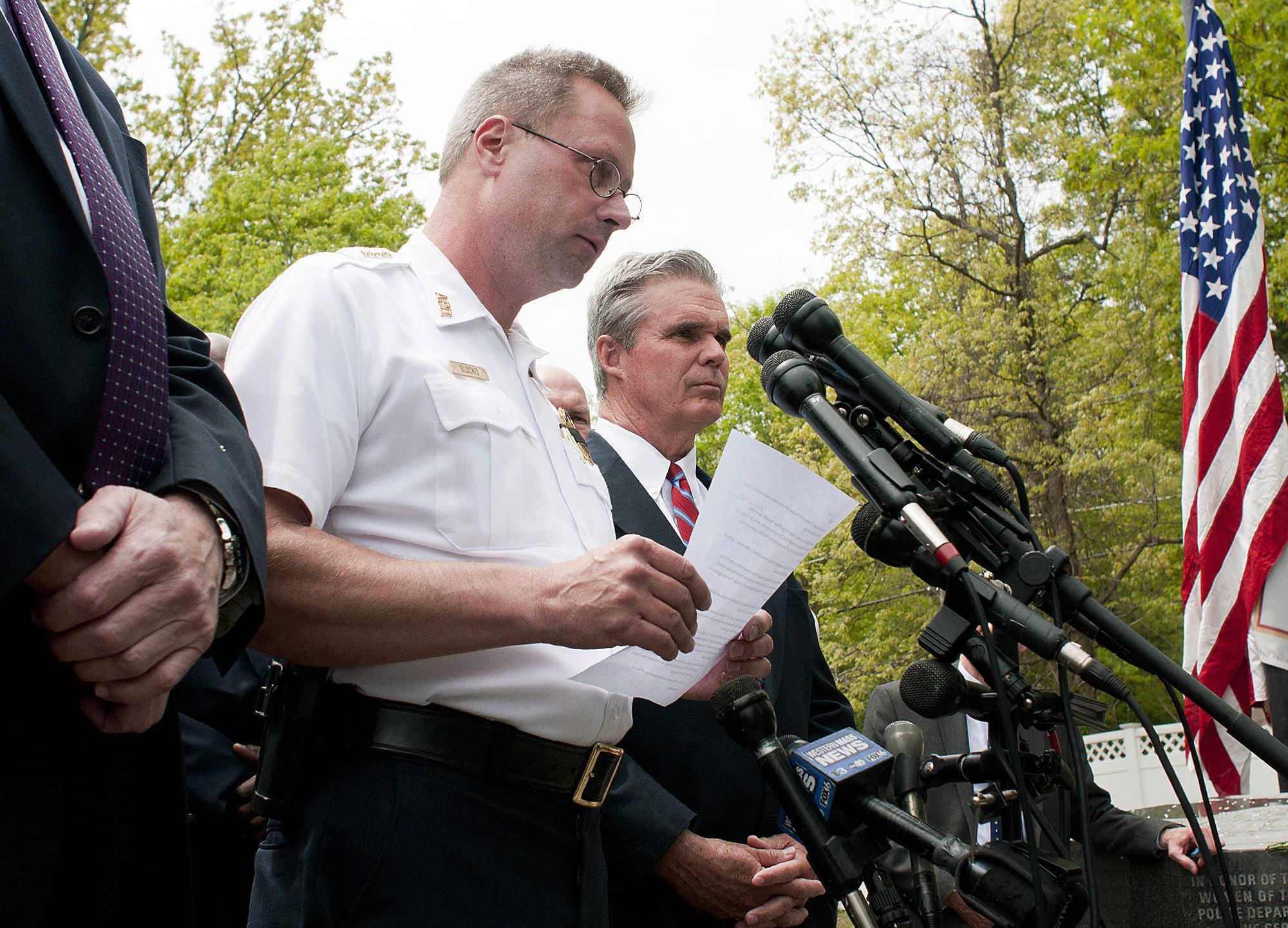 Rick Cinclair / Worcester Telegram & Gazette Auburn Police Chief Andrew Sluckis reads a statement about Auburn police Officer Ronald Tarentino who was was fatally shot during a traffic stop in Auburn, Massachusetts on Sunday. Worcester County District Attorney Joseph D. Early, Jr., (right) joins Sluckis at the briefing.