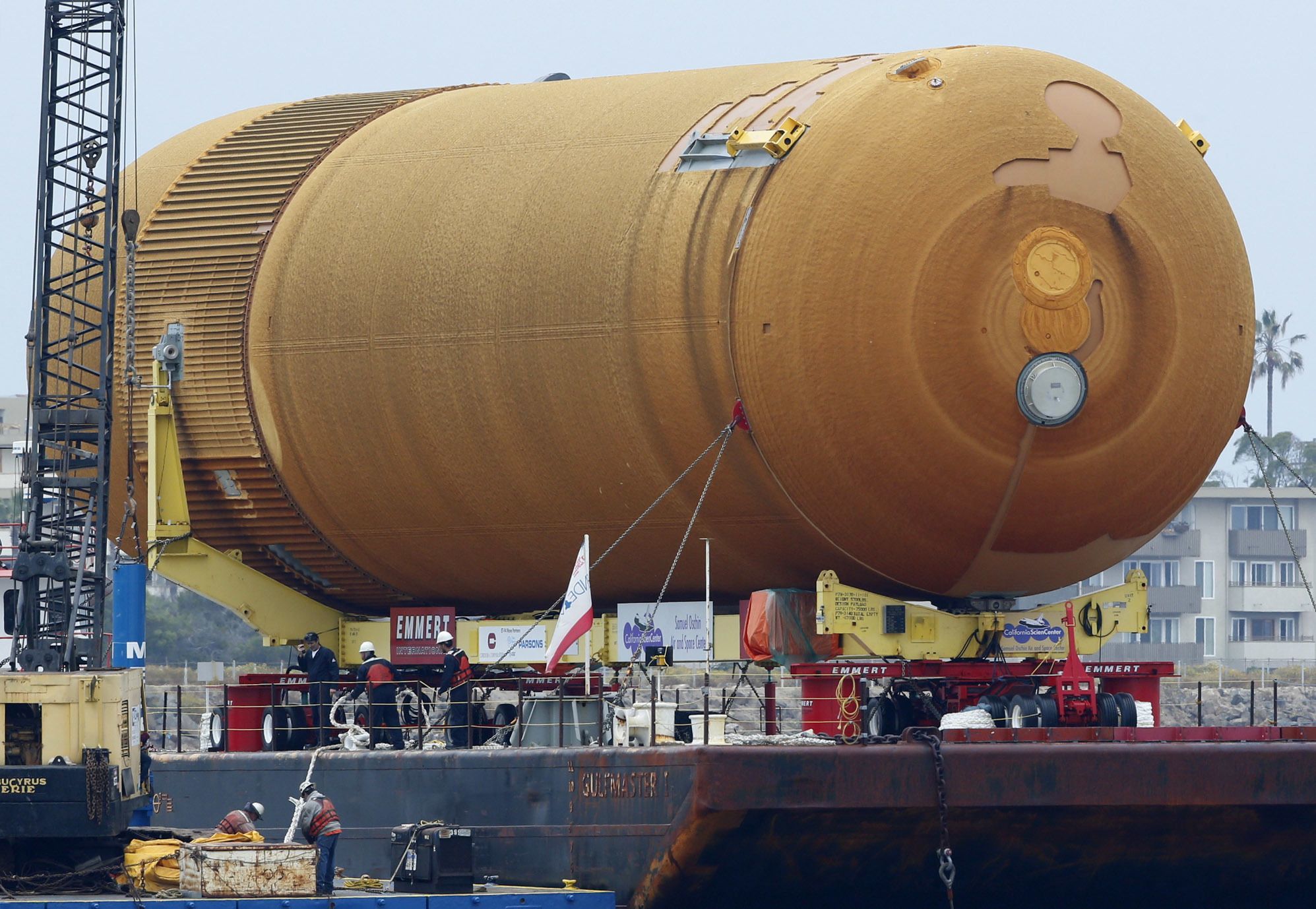The space shuttle external propellant tank ET-94, arrives aboard a barge at Marina del Rey, California, on Wednesday. NASA’s only remaining version of the tank will be placed on dollies and pulled by a truck to its final destination near the California Science Center’s Samuel Oschin Pavilion in Los Angeles.