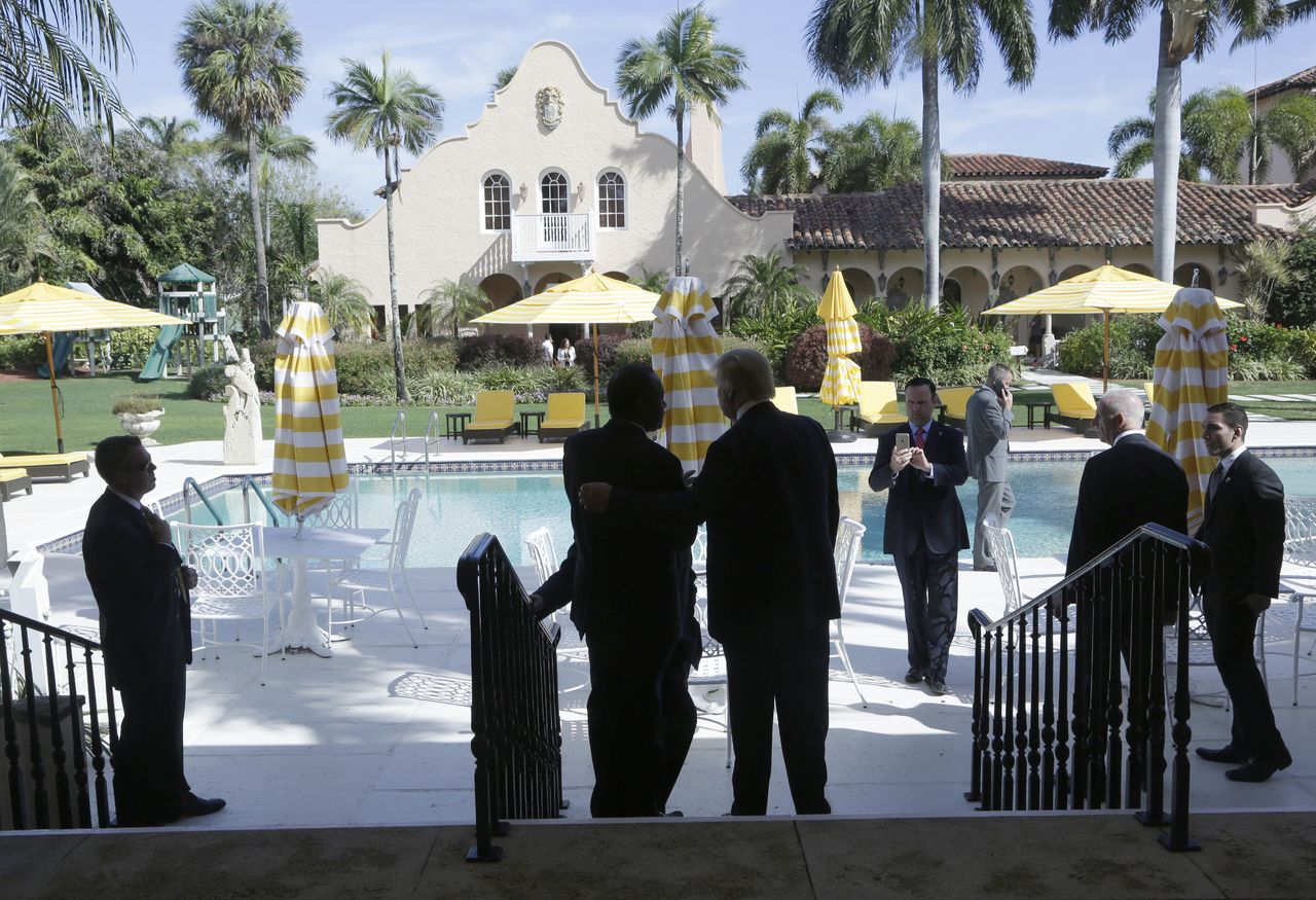 In this March 11 photo, former Republican presidential candidate Ben Carson (center left) talks with Donald Trump (center right) after a news conference at the Mar-A-Lago Club, in Palm Beach, Florida.