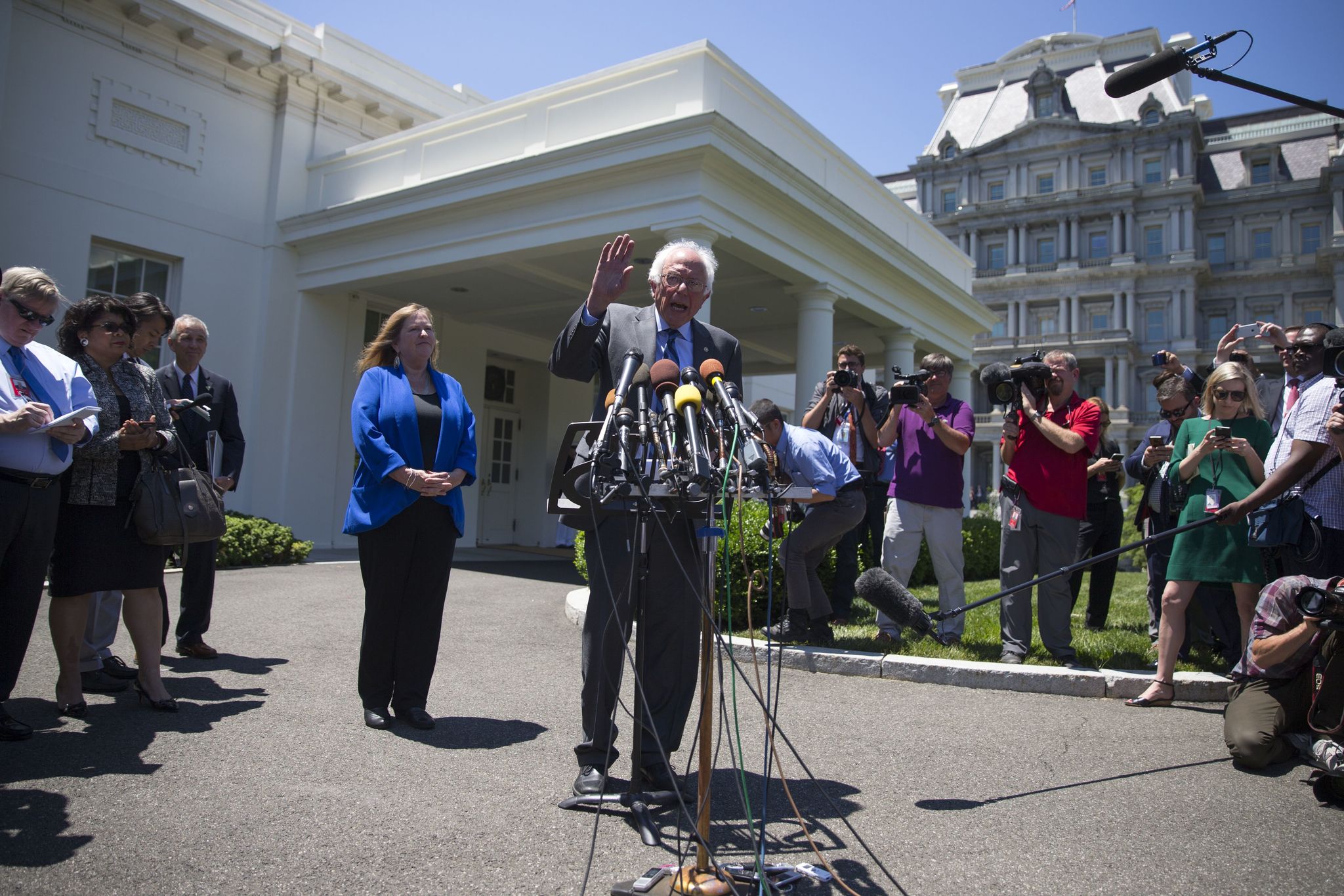 Democratic presidential candidate Sen. Bernie Sanders, accompanied by his wife Jane Sanders, speak to reporters outside the White House on Thursday.