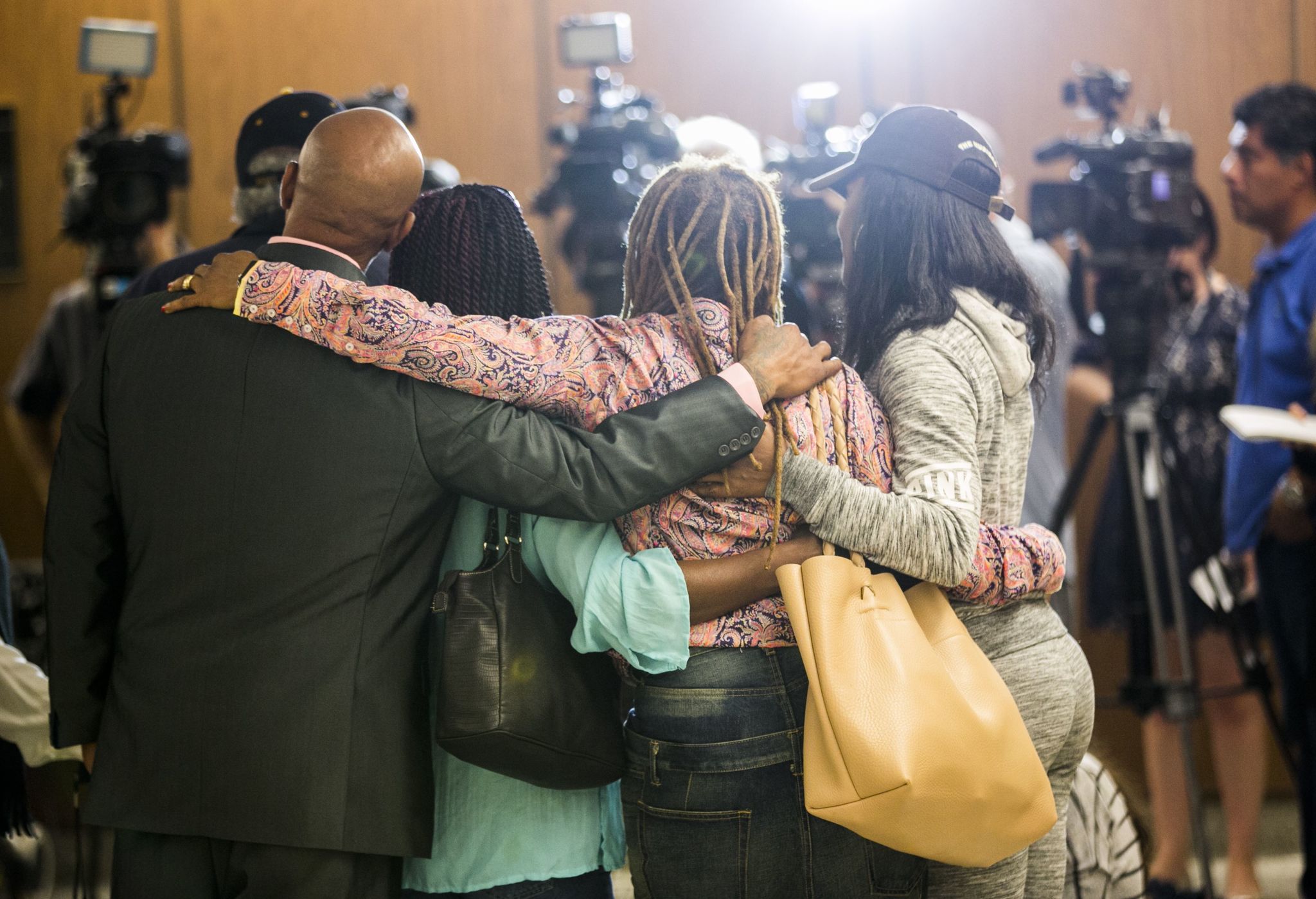 Family members of the victims of Lonnie Franklin Jr. hug as they take questions from the media after a jury decided Franklin should be sentenced to death for murdering nine women and a teenage girl, in Los Angeles Superior Court on Monday.