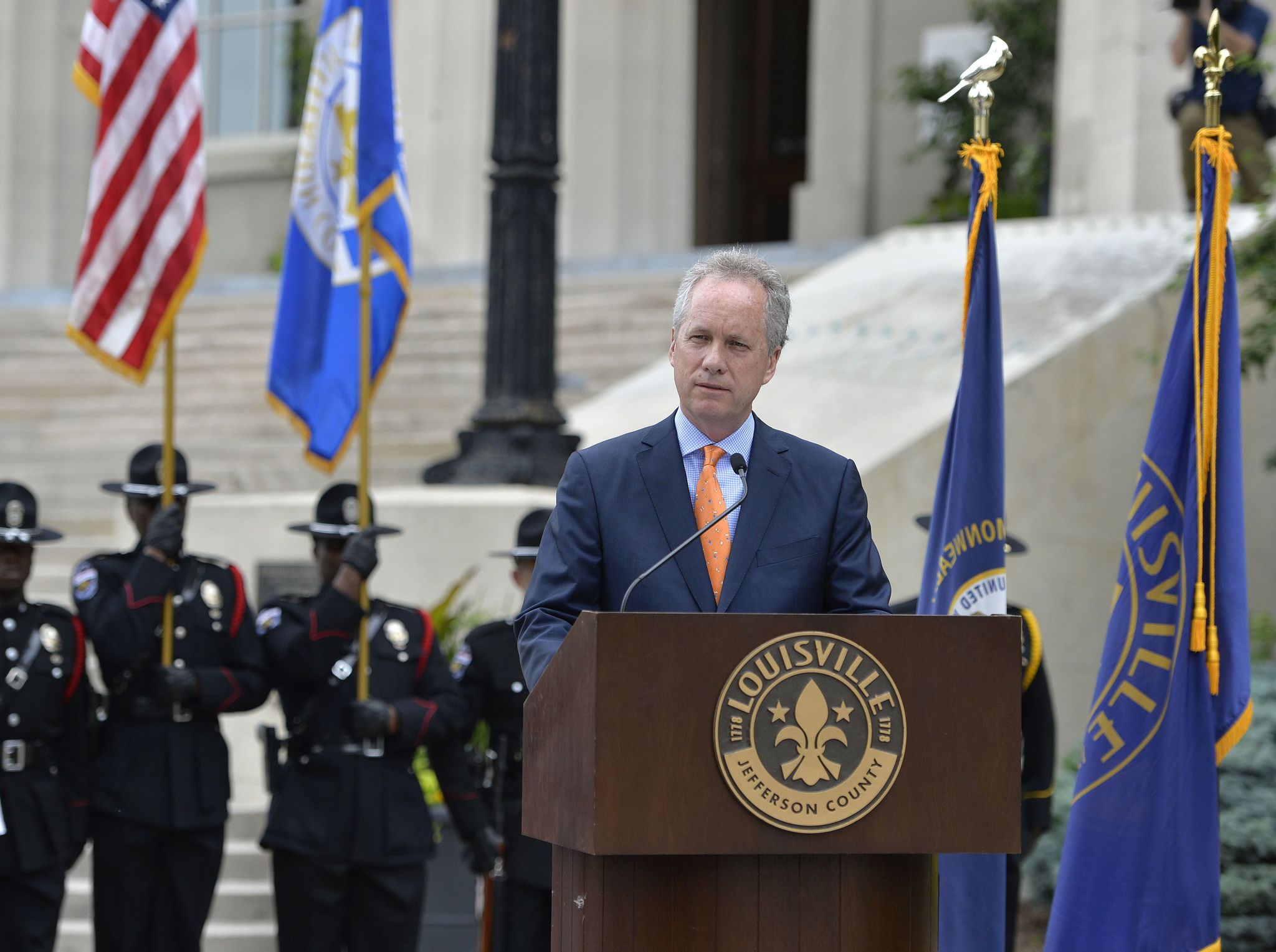 With the Metro Police Color Guard standing at attention, Louisville Mayor Greg Fisher addresses a gathering of supporters and mourners of Muhammad Ali from the steps of the Louisville City Hall on Saturday in Louisville Kentucky.