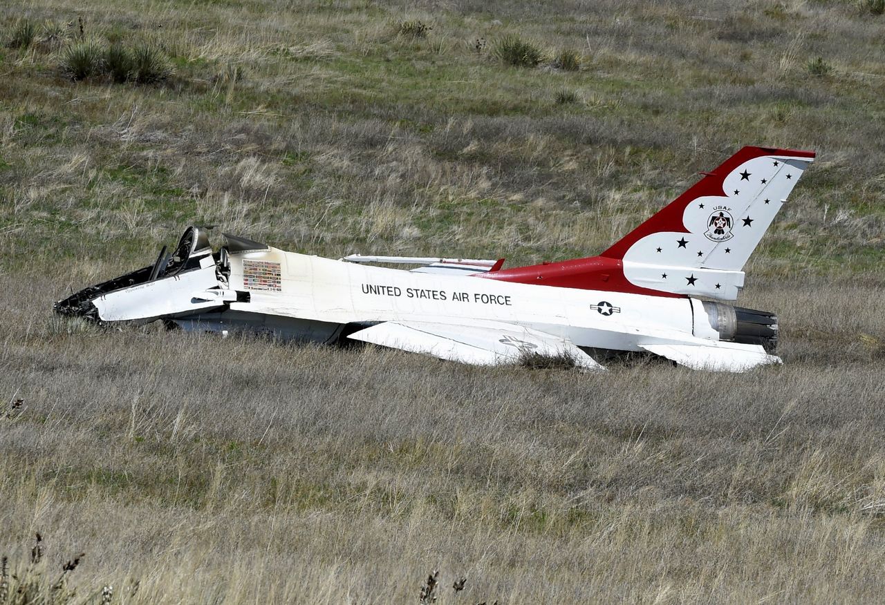A U.S. Air Force Thunderbird that crashed after a flyover rests on the ground south of the Colorado Springs, Colorado, airport Thursday.
