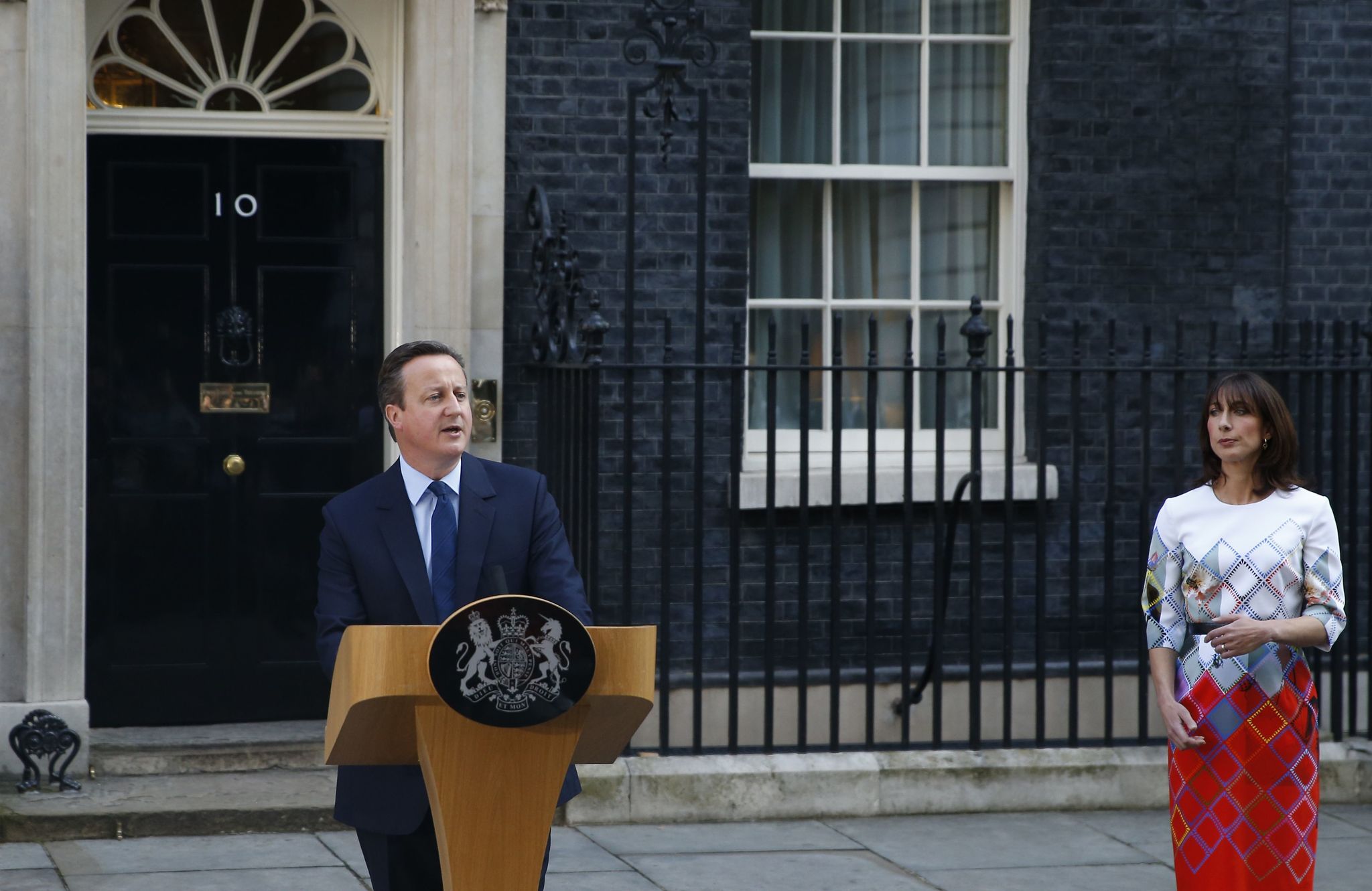 British Prime Minister David Cameron, accompanied by his wife, Samantha, speaks to the media in front of 10 Downing Street in London on Friday, saying he will resign.
