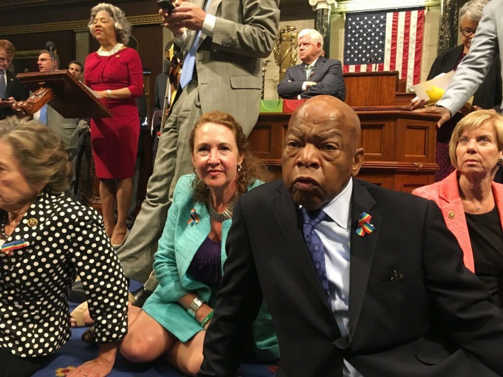 Democratic members of Congress, including Rep. John Lewis, D-Ga., center, and Rep. Elizabeth Esty, D-Conn., participate in sit-down protest seeking a a vote on gun control measures Wednesday on the floor of the House on Capitol Hill in Washington.